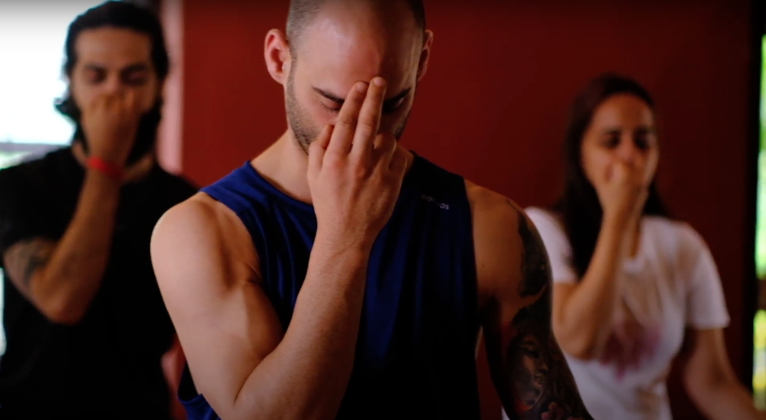 Participants in a breathing practice, eyes closed, in a pranayama class at Yukah.