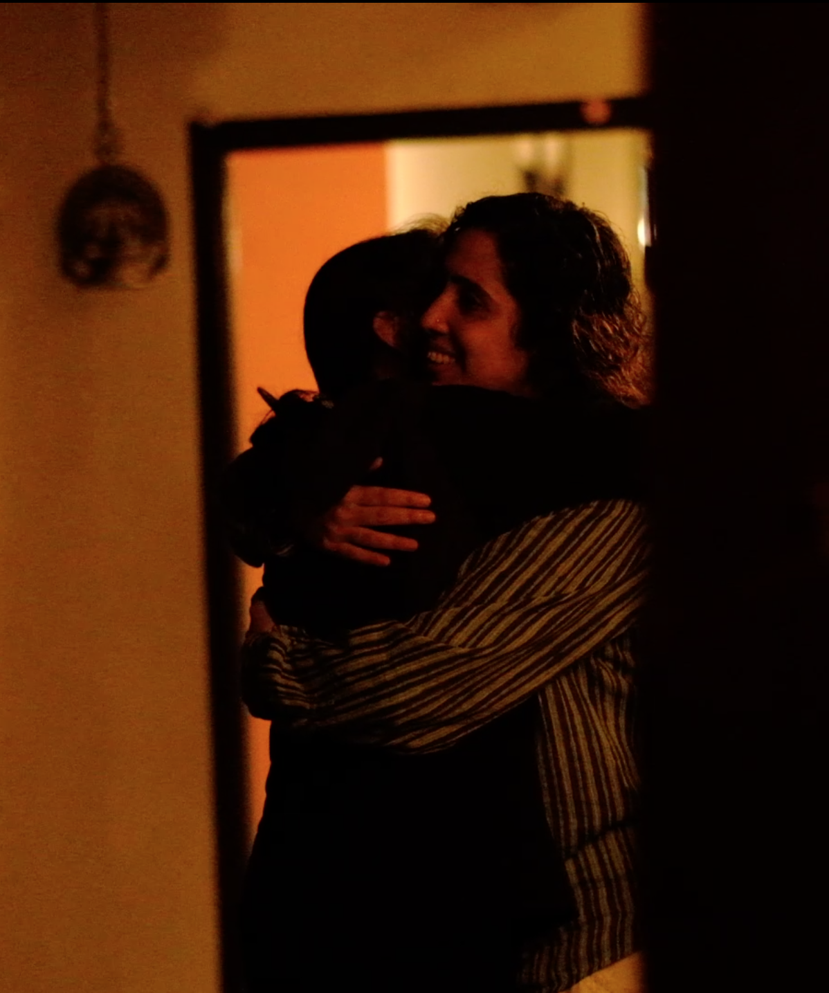 Two participants sharing a warm goodbye at the close of a Yukah programme.
