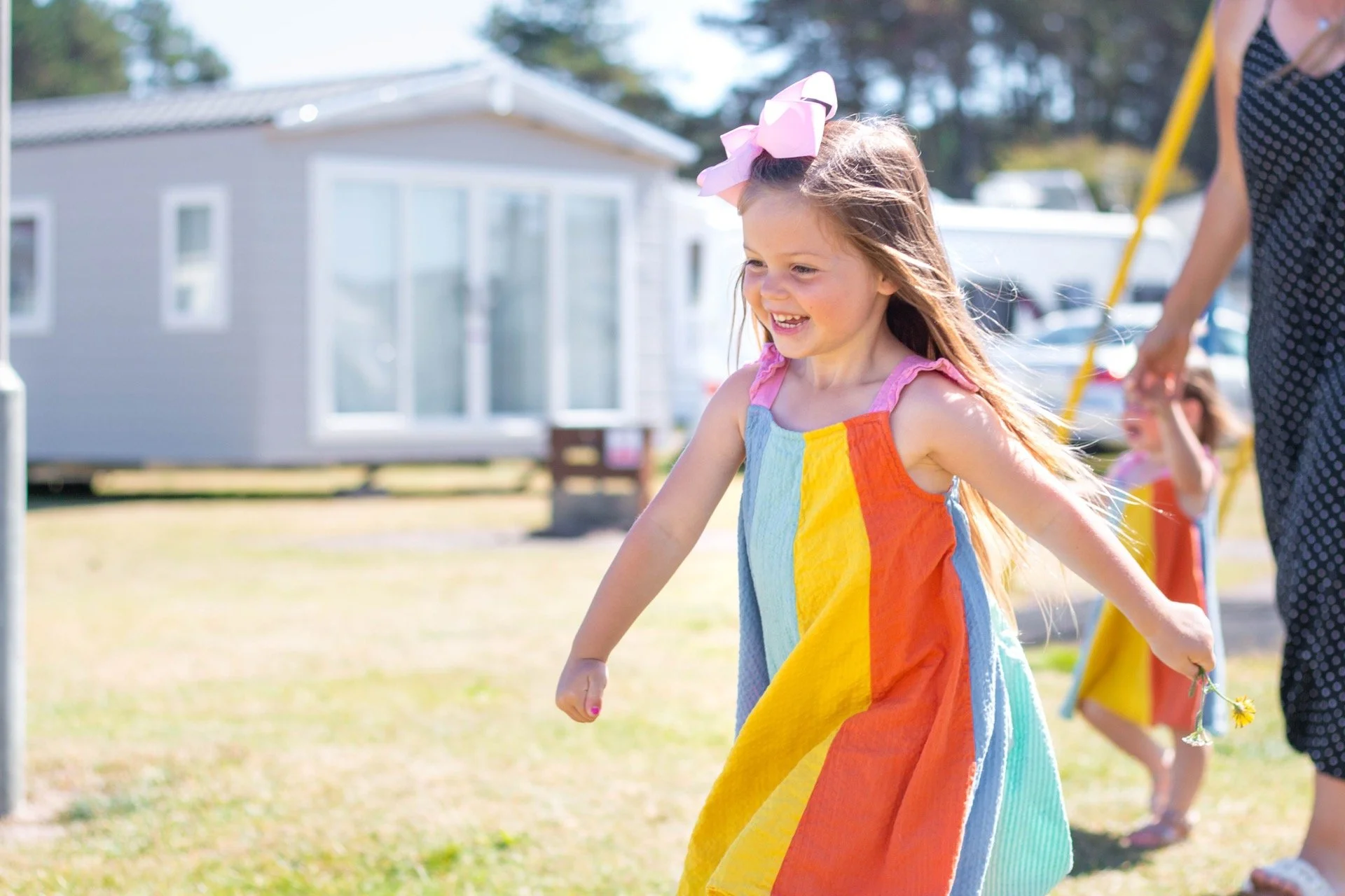 burghead-holiday-park-homes-behind-child-running-with-mum-2.jpg