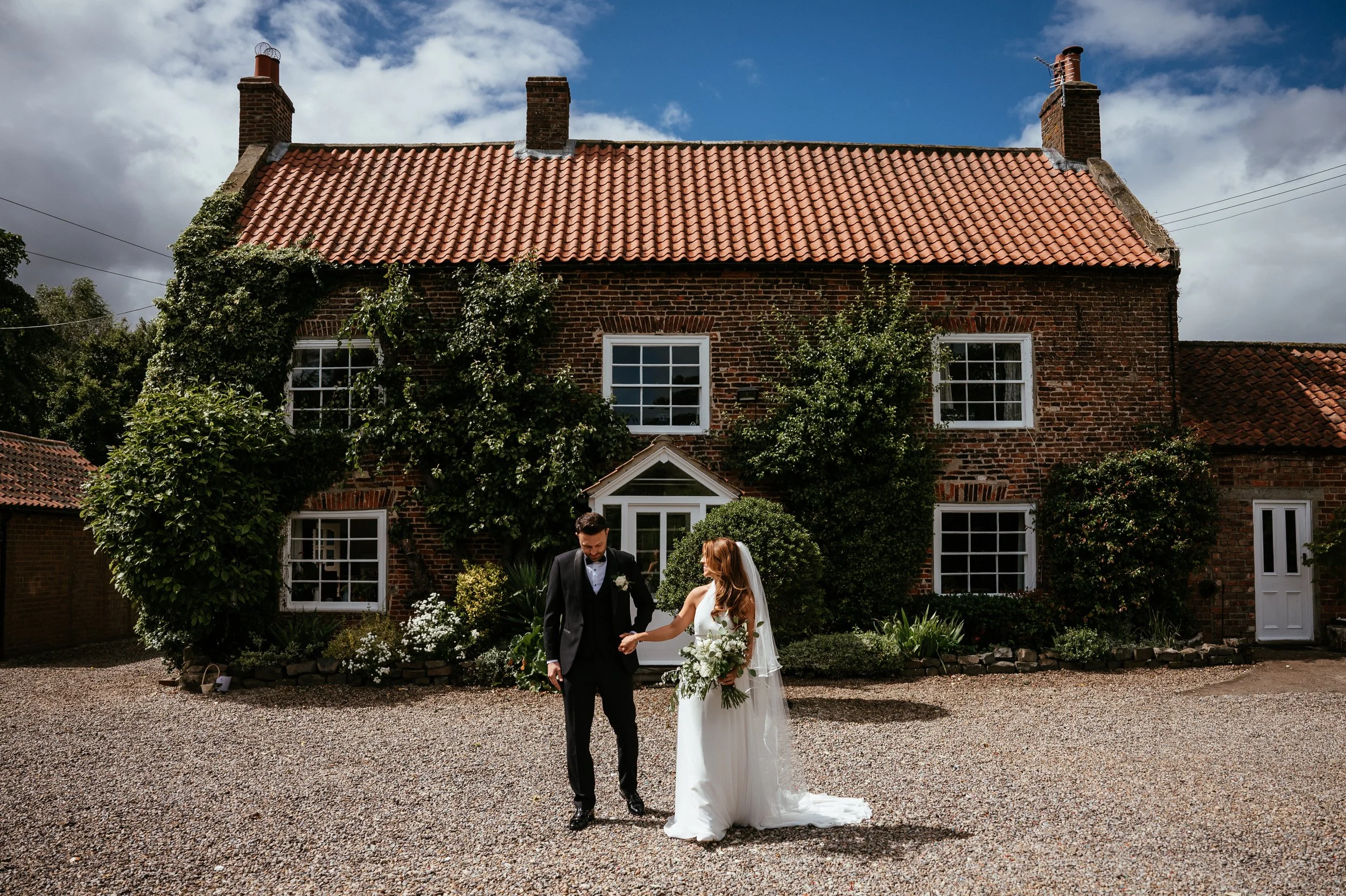 bride and groom pictured in front of wedding venue in north yorkshire