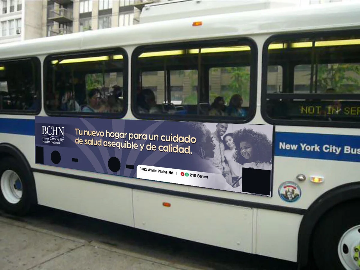 A New York City bus with an advertisement in Spanish for the Bronx Community Health Network, featuring a group of diverse people smiling.