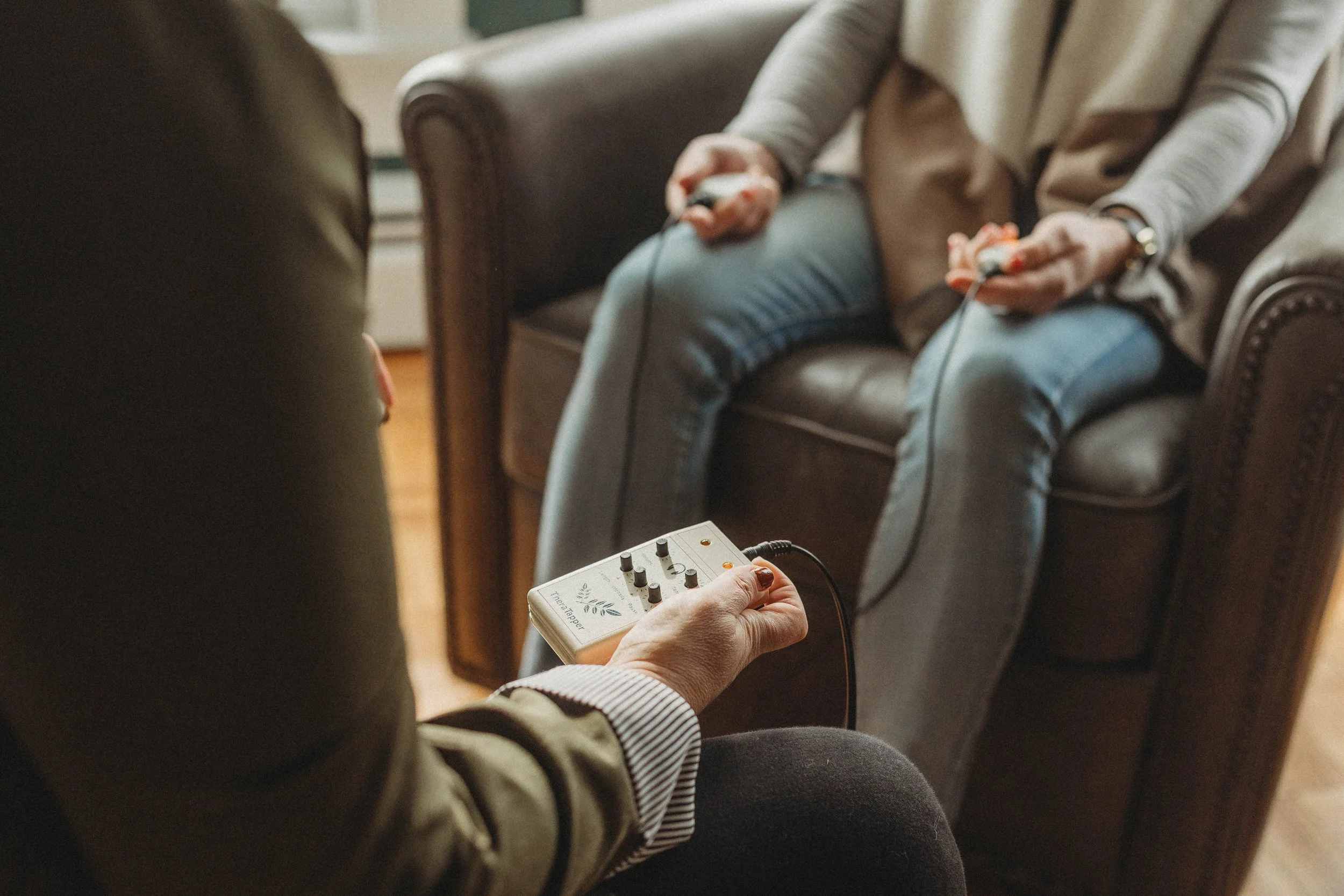 An image of a therapist using tappers for EMDR therapy.