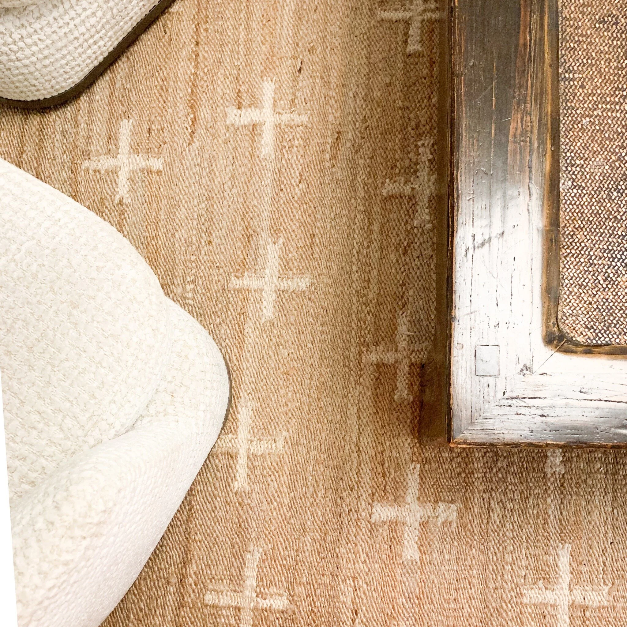 A detail of a recent living room where we mixed old and new to create a warm and earthy interior.
A neutral colour scheme tends to be our go-to, offering a sense of calm while still feeling inviting. Introducing a jute rug is a great way to add warm
