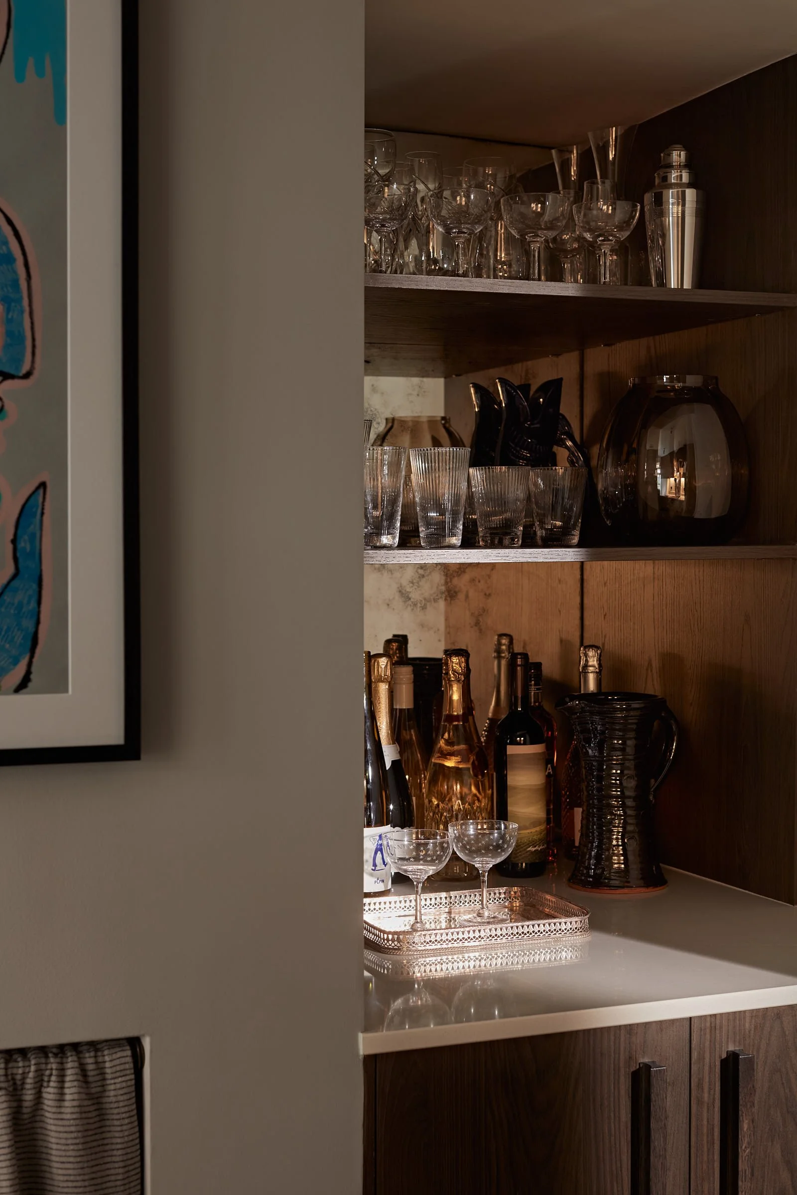 Drinks cabinet with wine glasses, champagne flutes and a cocktail shaker