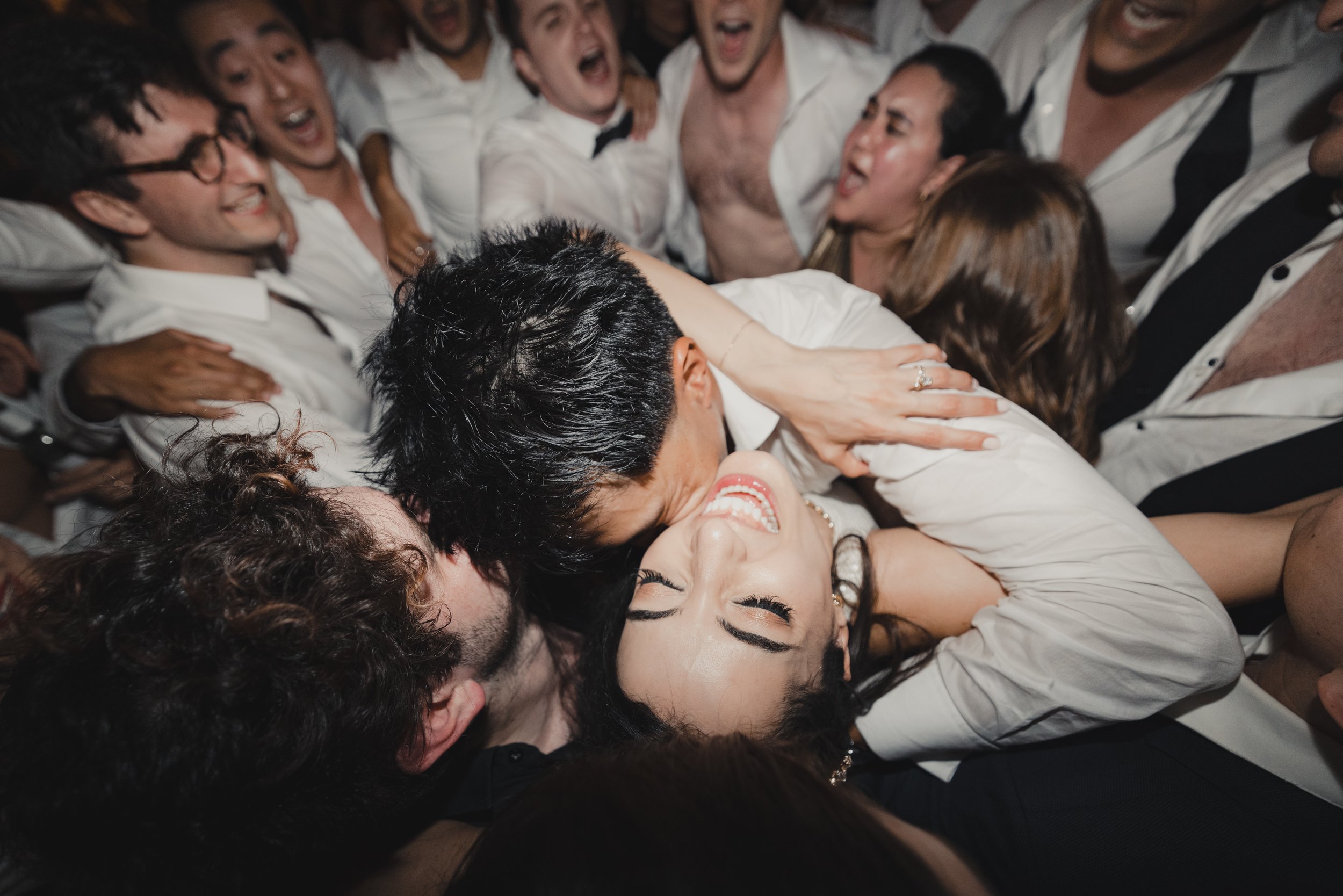 Embracing Love on the Dance Floor: Couple Surrounded by Family and Friends at Penn Museum