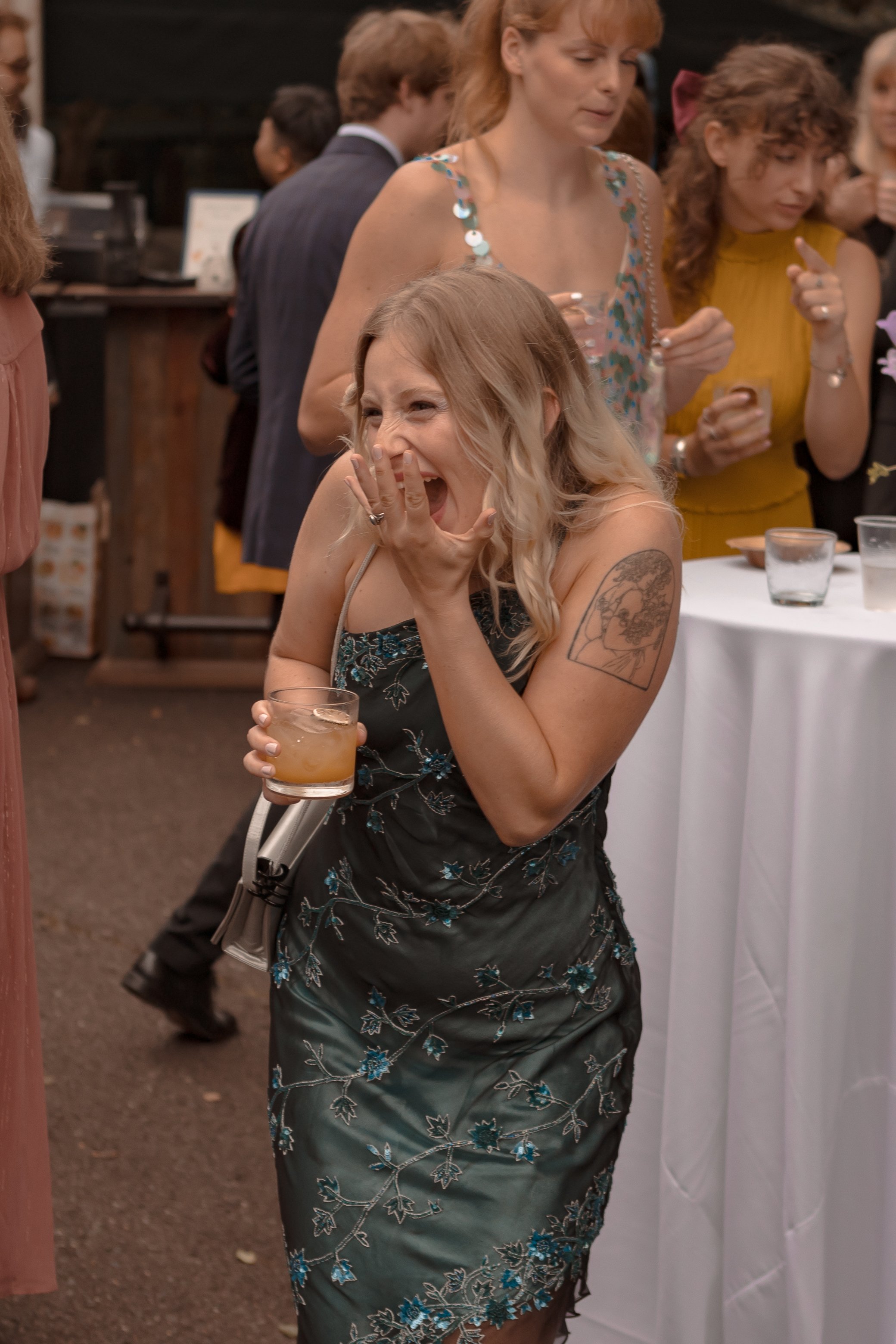 Joyful Candid Moment: Bride's Friend Laughing at Ridgeland Mansion