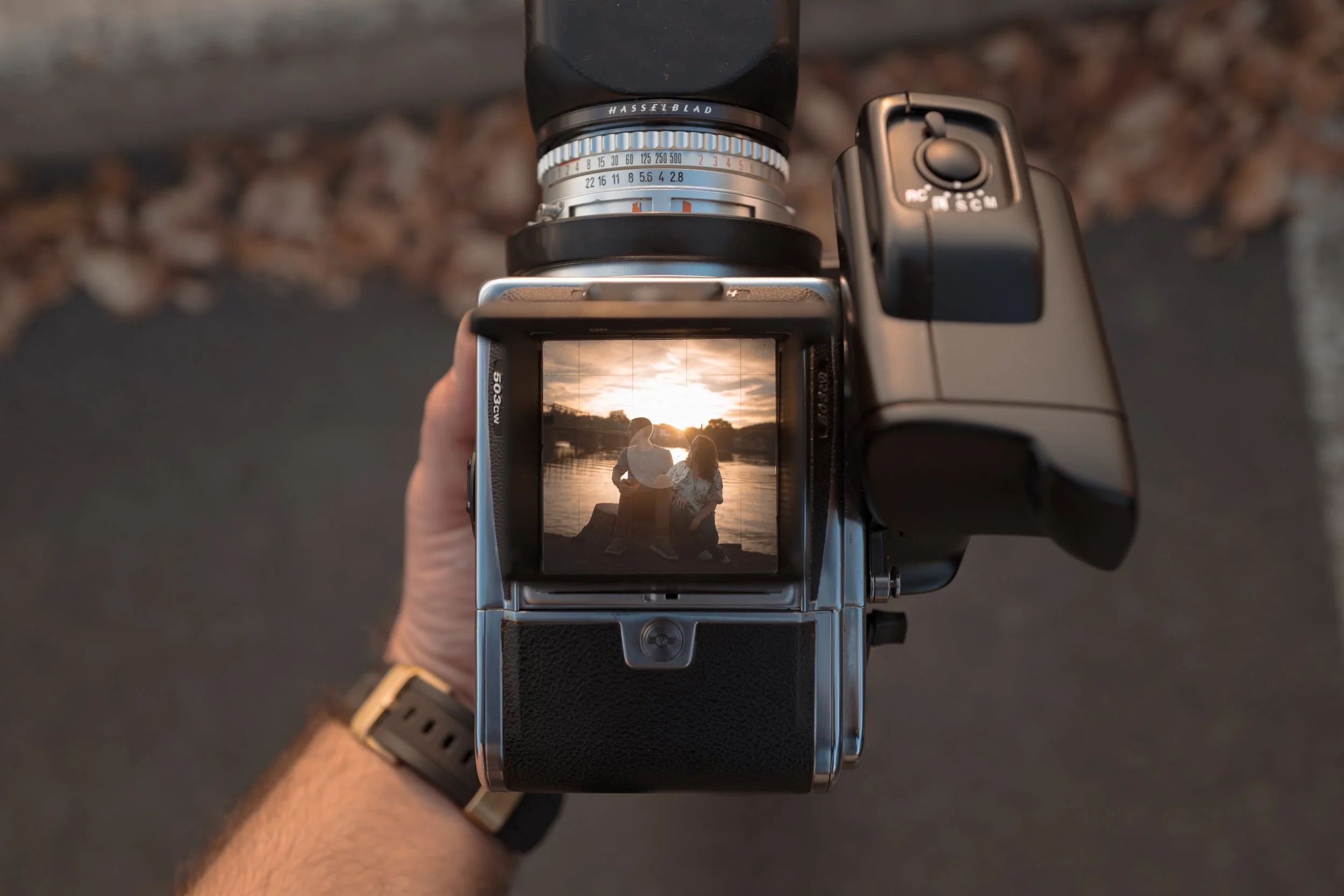 Hasselblad medium format film camera showing an engagement portrait through the viewfinder