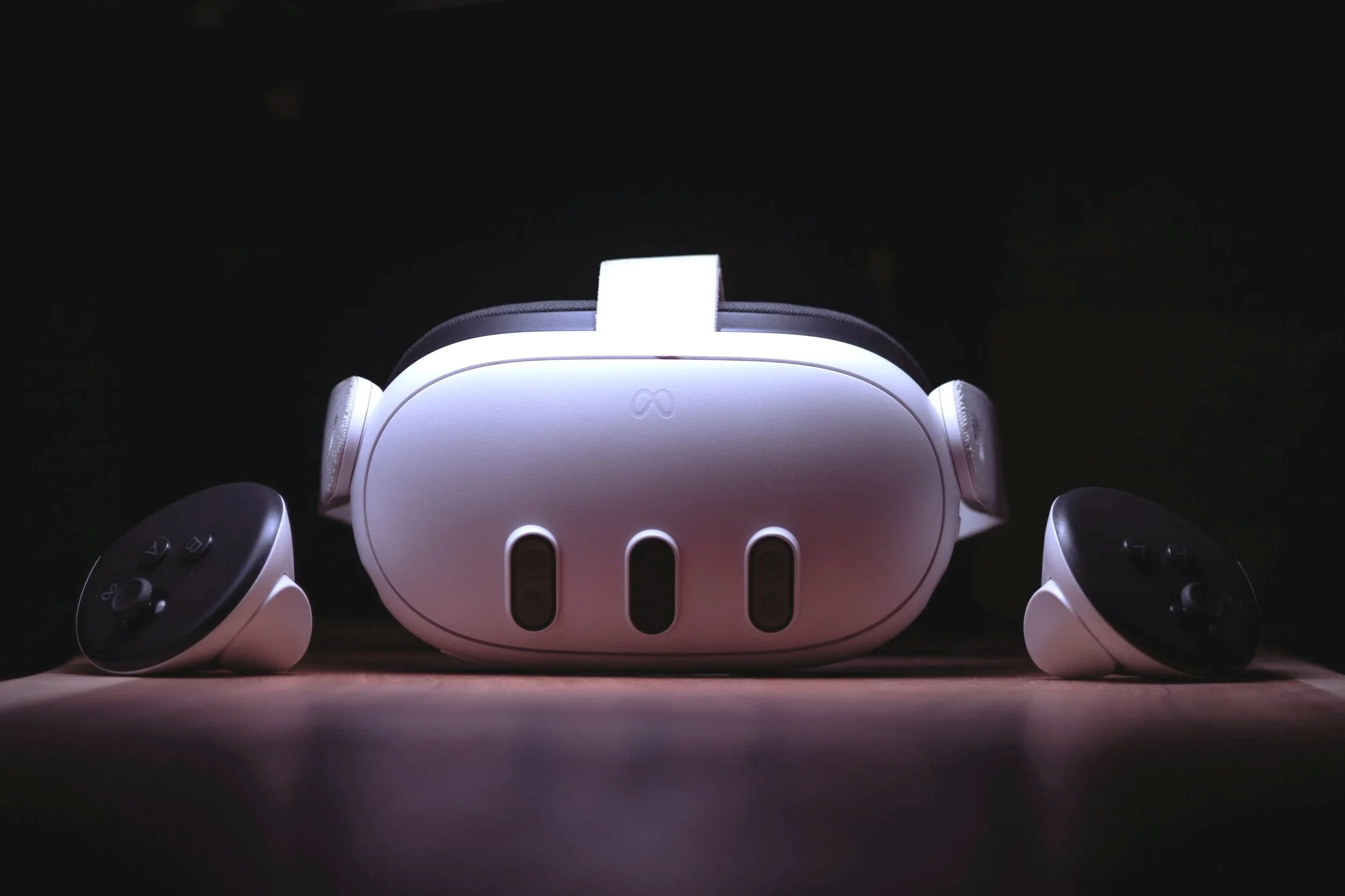 A white virtual reality headset with attached headphones on a plain white background.