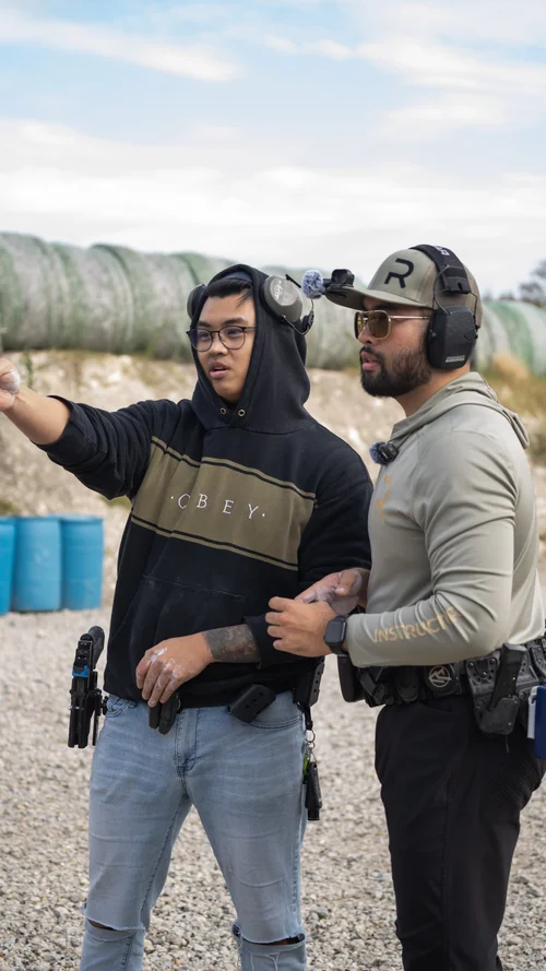 Instructor Andy Dang coaching a pistol student at Rooftop Shooting Range in Trenton, TX