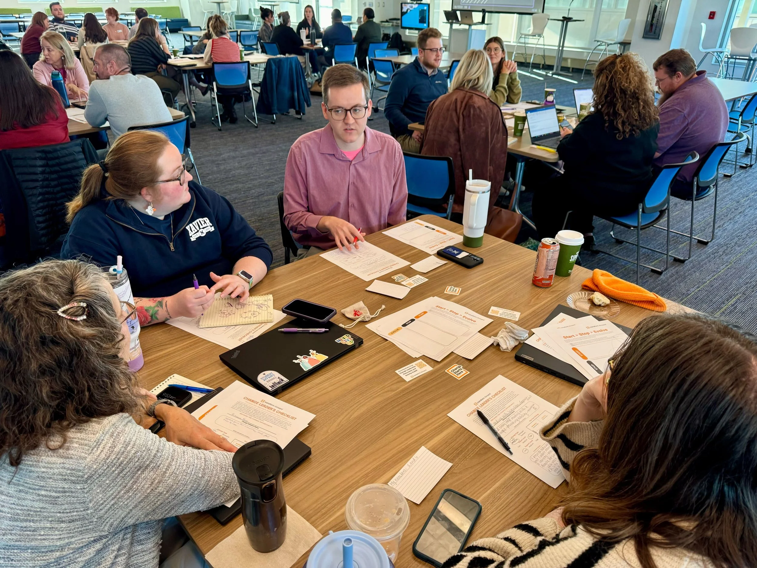 On-site photo: leadership team in the visioning session, individual reflection or small group synthesis in progress