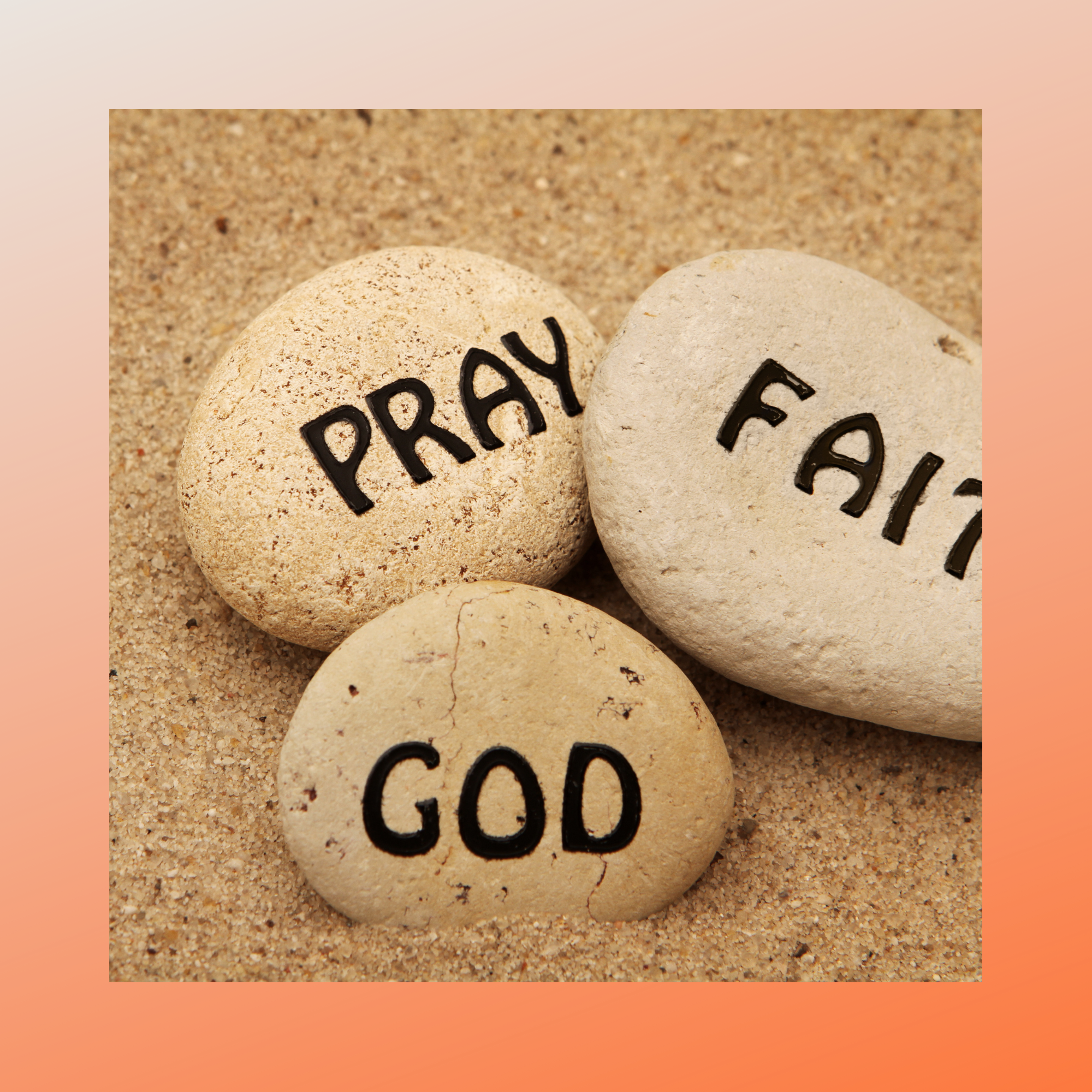 Three stones with PRAY, GOD and Faith written on them in black lettering