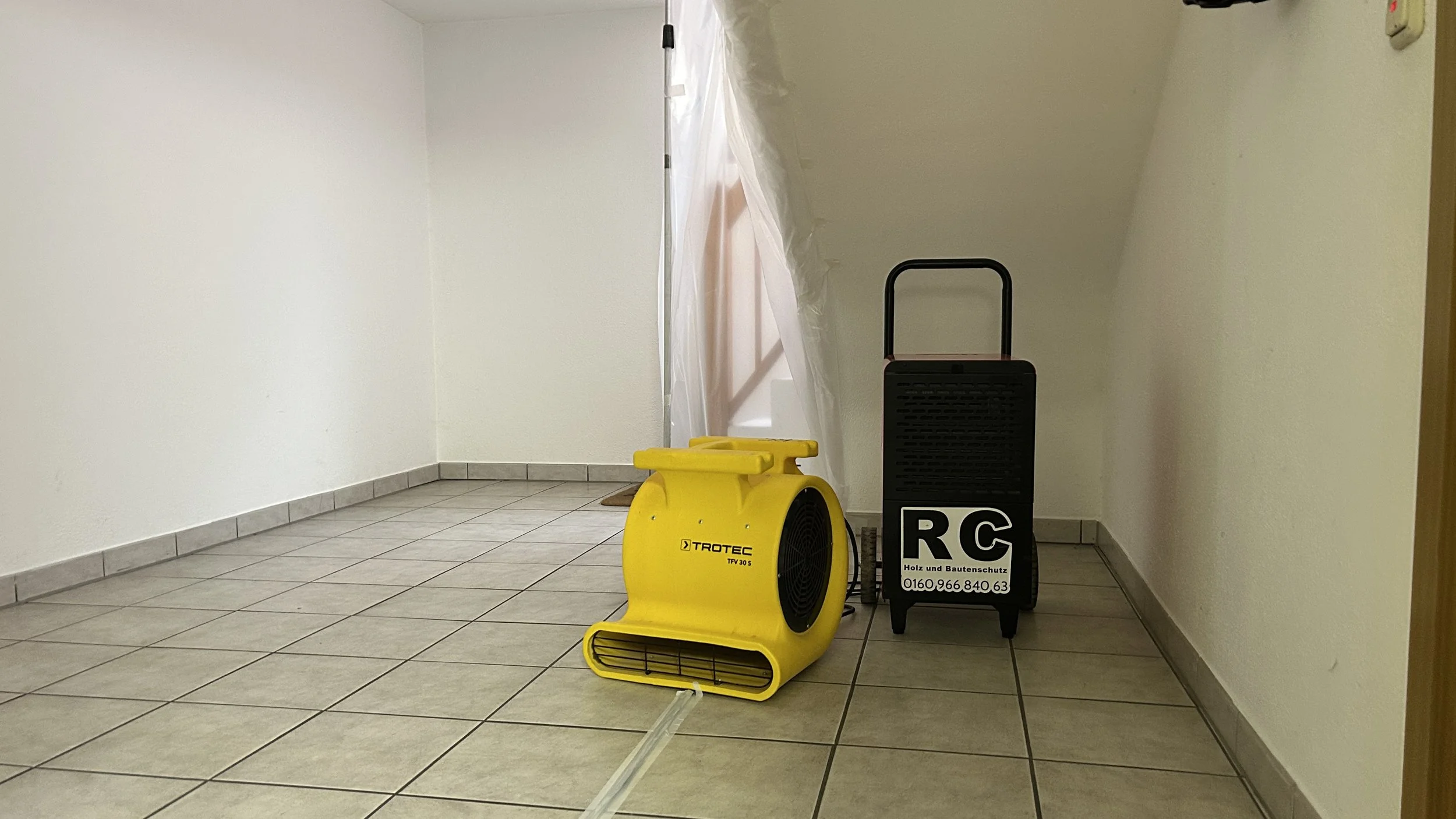 Professionelle Wand und Raumtrocknung in Raubling mit Bautrockner und Luftentfeuchter zur kontrollierten Entfeuchtung feuchter Wände, Raumluft und Bodenbereiche