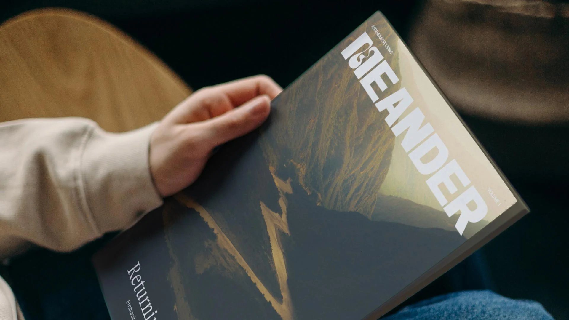A person holding Meander Magazine issue 1