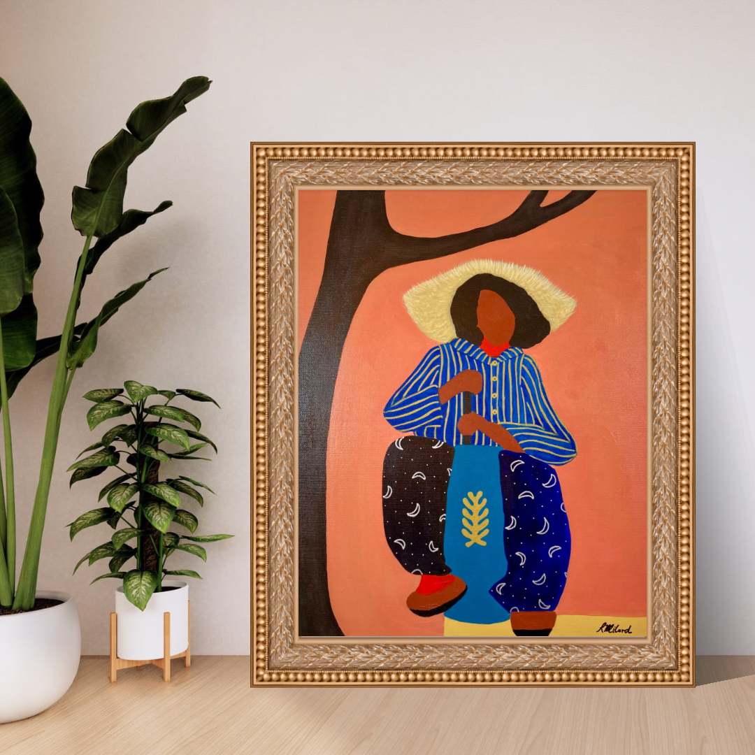Colorful painting of a woman with dark skin and dark hair standing under a tree with a pink background. The woman is wearing a striped blue and yellow shirt, blue pants with white crescent moons, and a wide-brimmed straw hat. The painting is framed with an ornate gold frame and is placed on a wooden surface next to two potted plants.