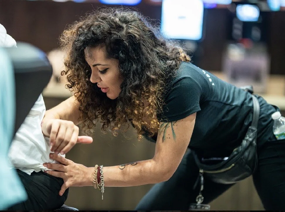 Casino guest receiving a chair massage during a poker event
