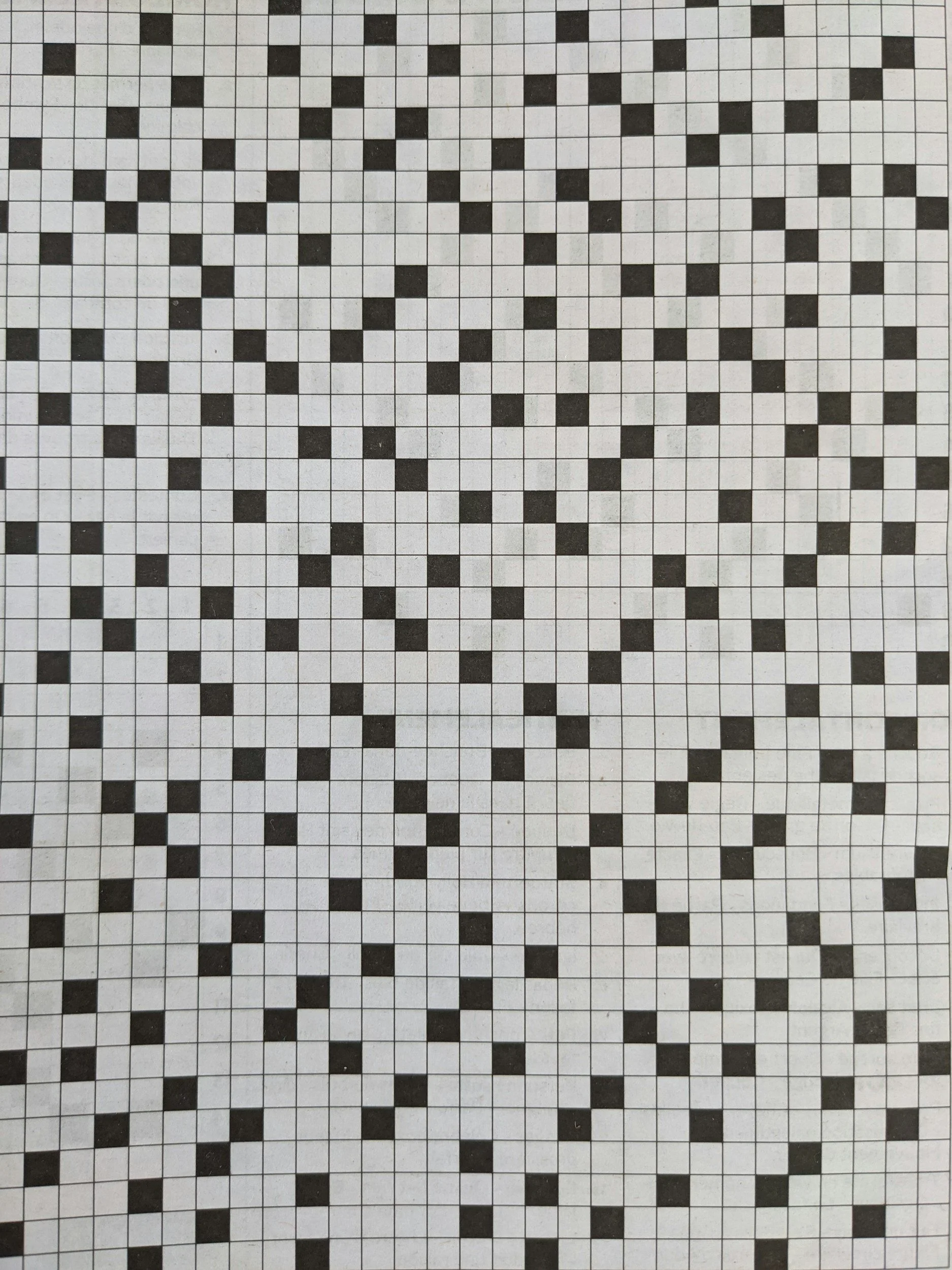 A patterned tile floor with a black and white geometric mosaic design.