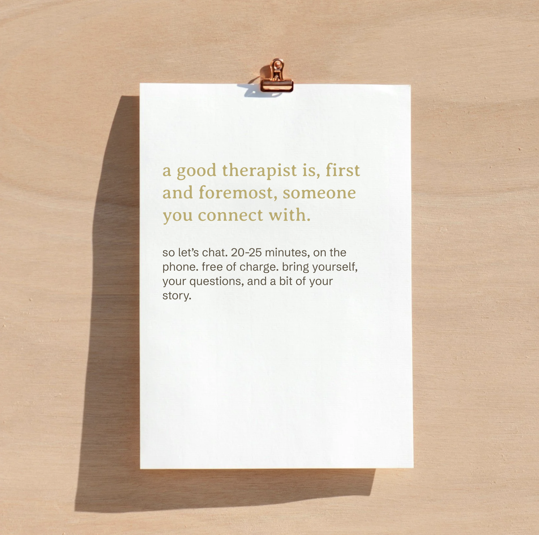 A printed quote on a white sheet of paper clipped to a brown background, reading, "a good therapist is, first and foremost, someone you connect with" with additional smaller text below.