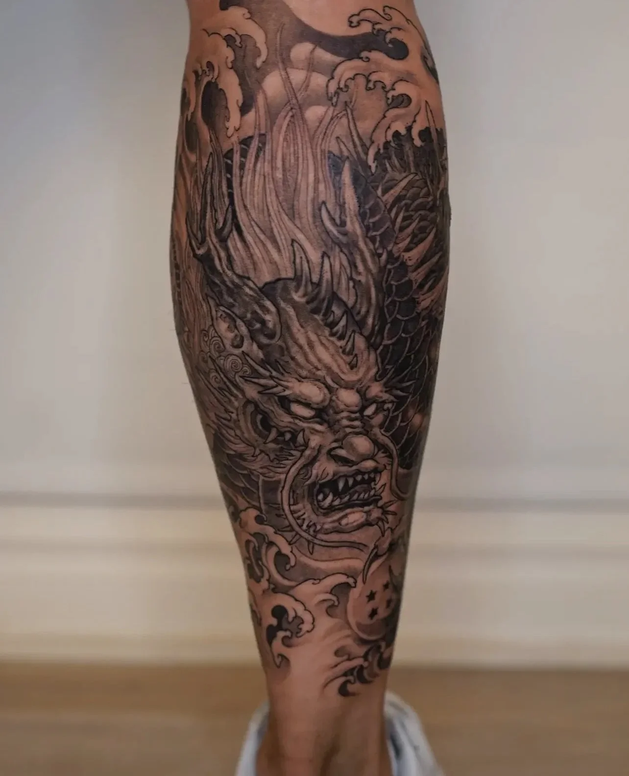 Dragon on the calf 🐉 
Artist: @yokaiink 
________________________________________________
[At Off the Ground Ink, we bring your tattoo ideas to life! 💭 For bookings and inquiries, reach out to us by email at offthegroundink@gmail.com]