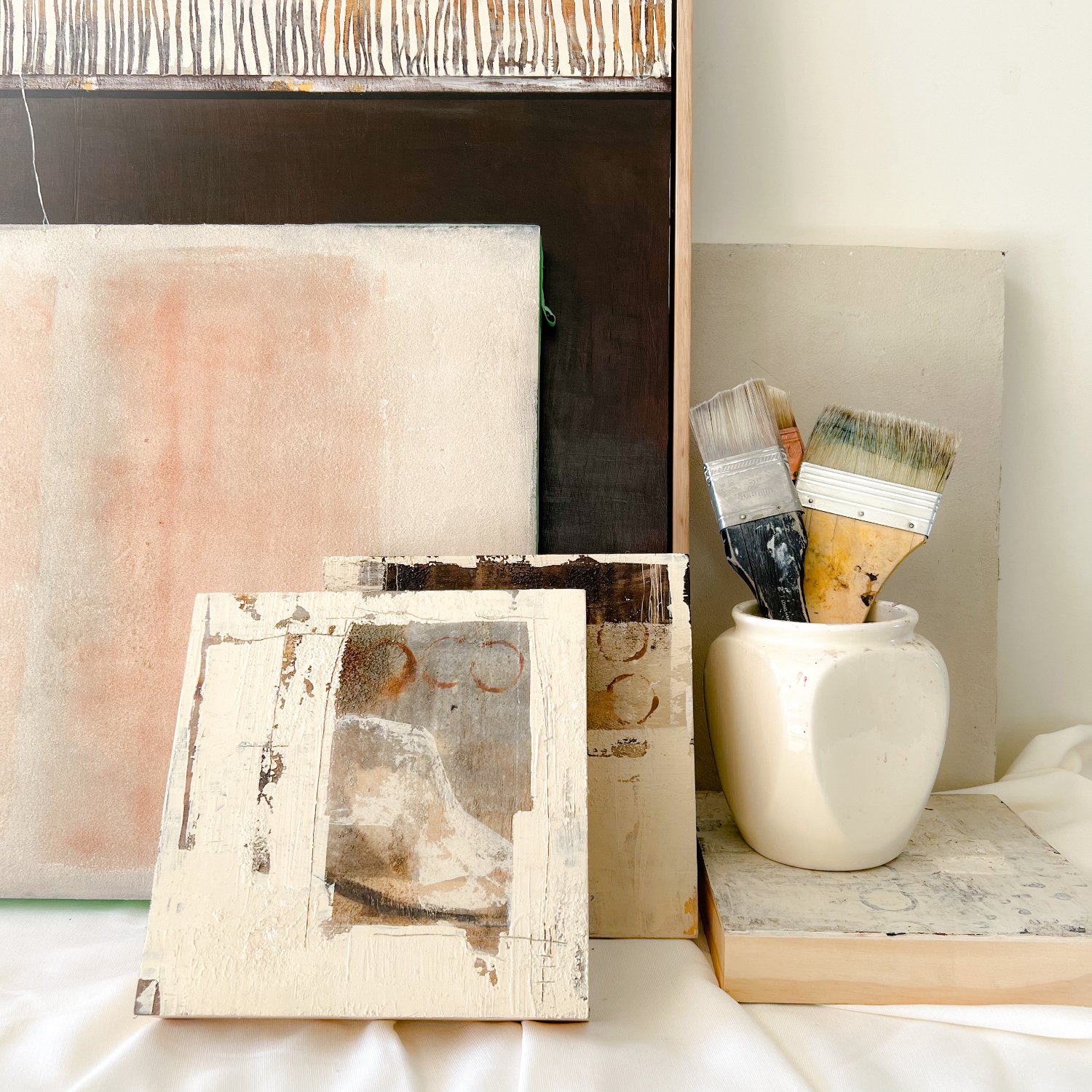 Paint brushes and mixed media artworks