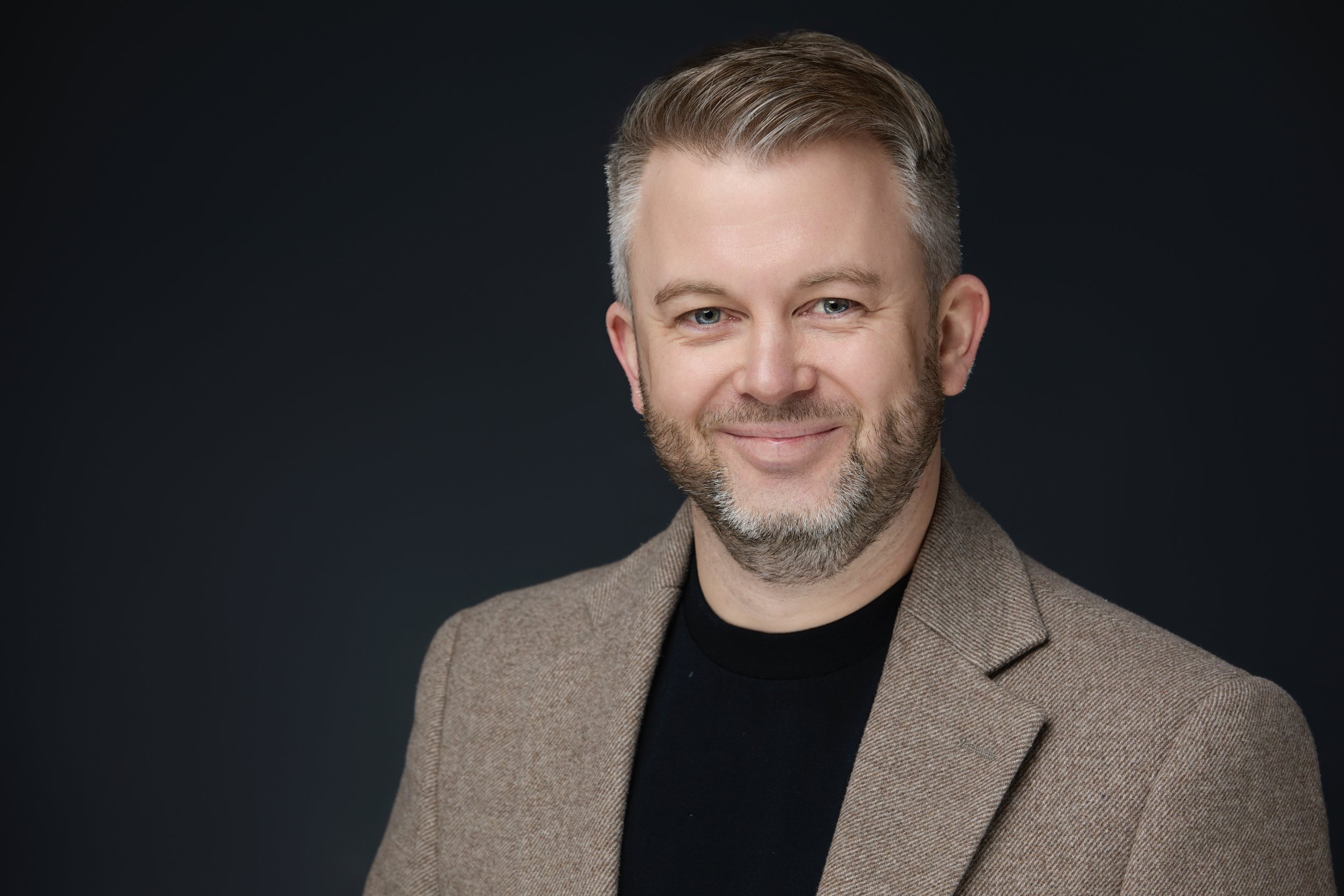 Studio headshot for LinkedIn profile, clean neutral background