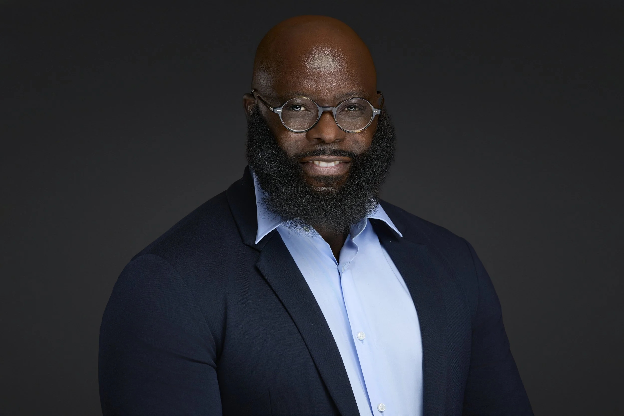 Business headshot of professional with neutral background