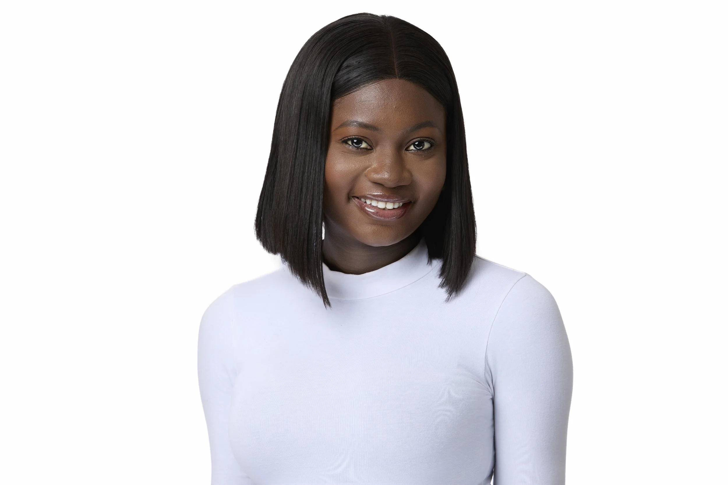 Portrait of a young African American woman with shoulder-length straight black hair, wearing a white long-sleeve top, smiling, against a plain white background.