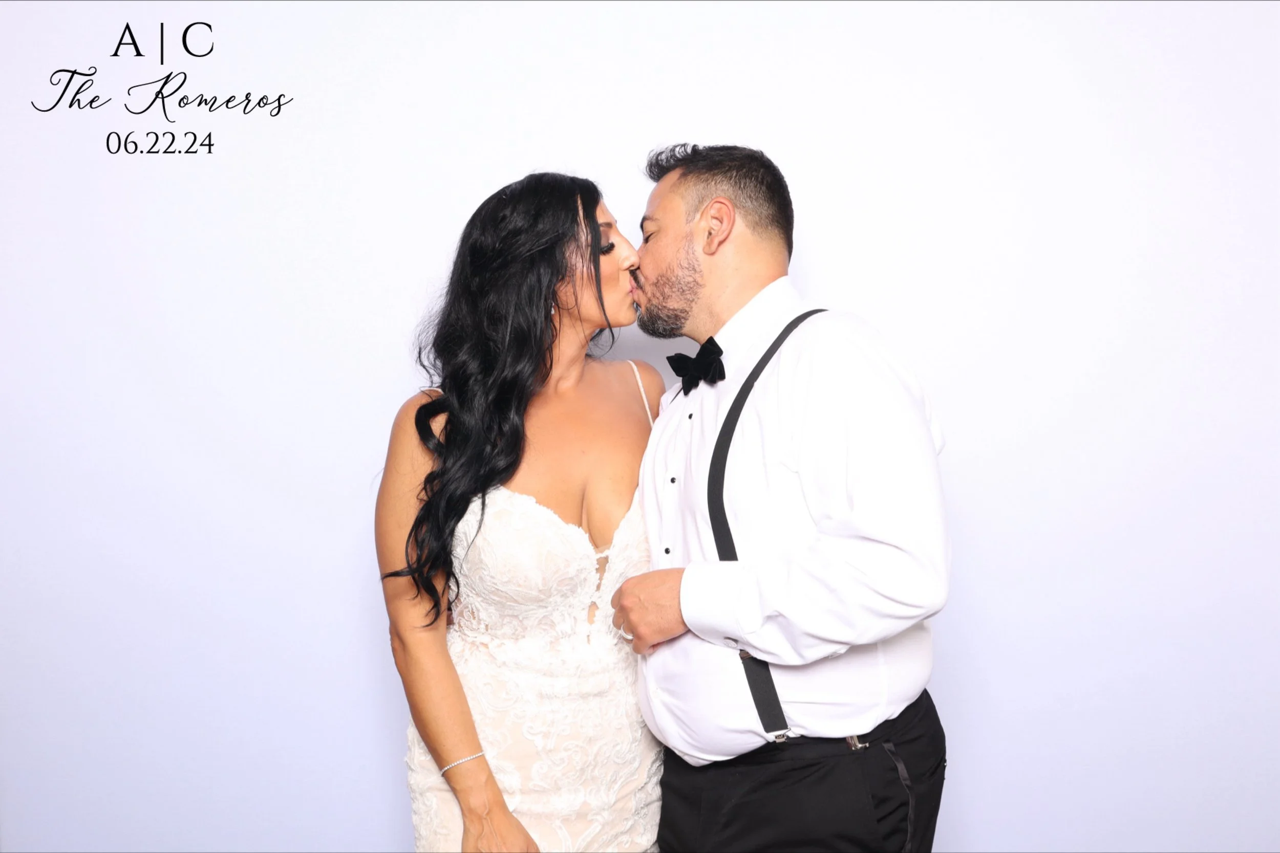A couple dressed in wedding attire sharing a kiss in front of a white background, with text indicating a wedding date of June 22, 2024.