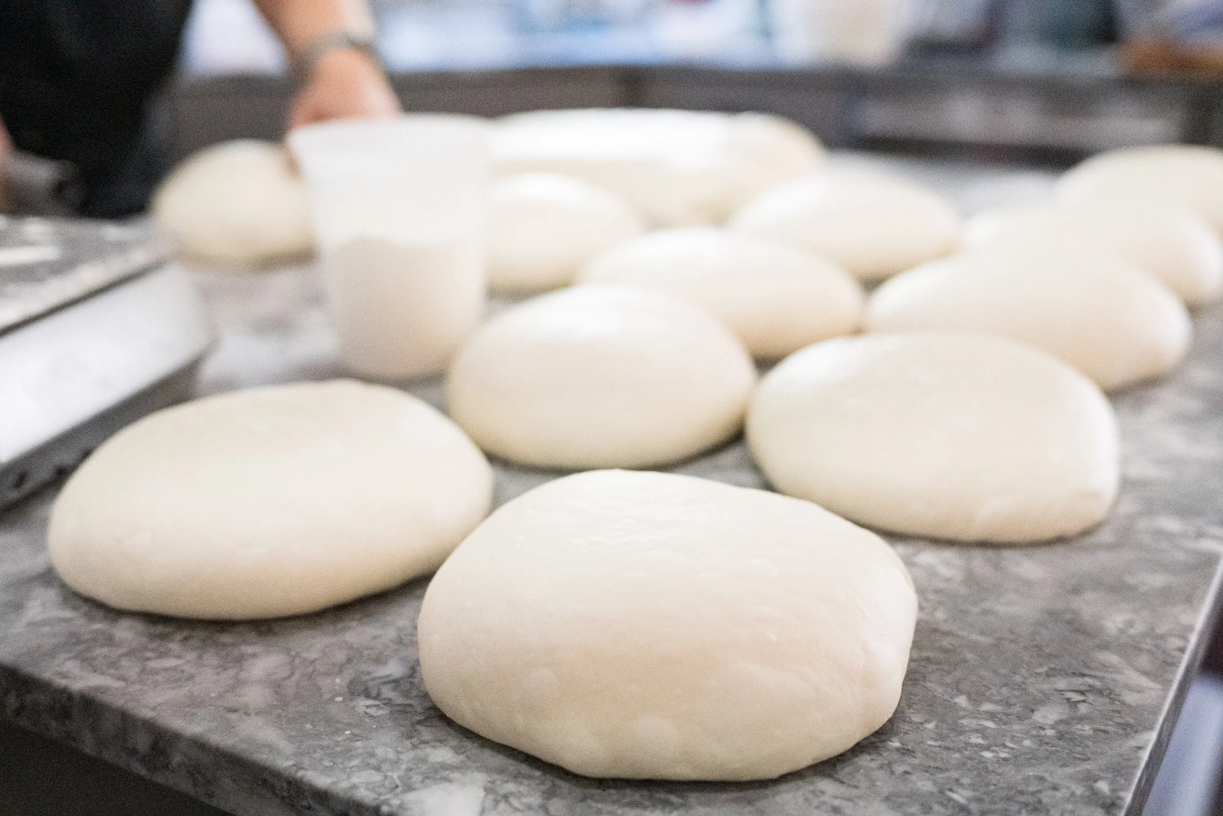 Liron shaping sourdough bread dough by hand at Moonflower Bakes Austin