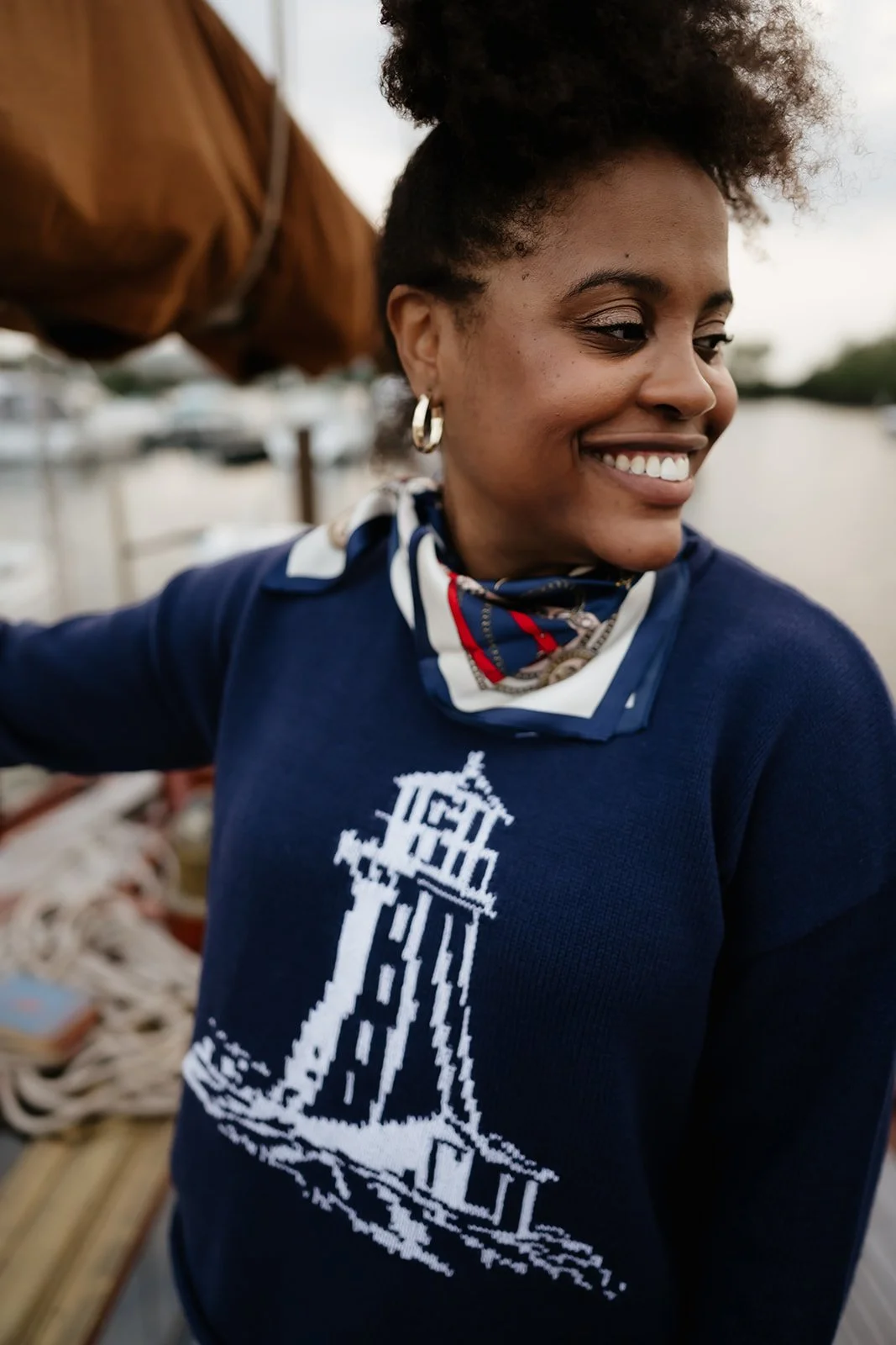 Navy lighthouse sweater with white coastal lighthouse design, a nautical knit for fall.