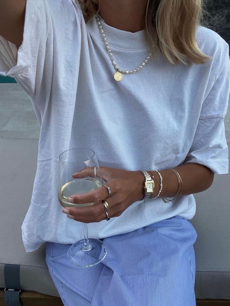 Layered coastal pearl and gold jewelry