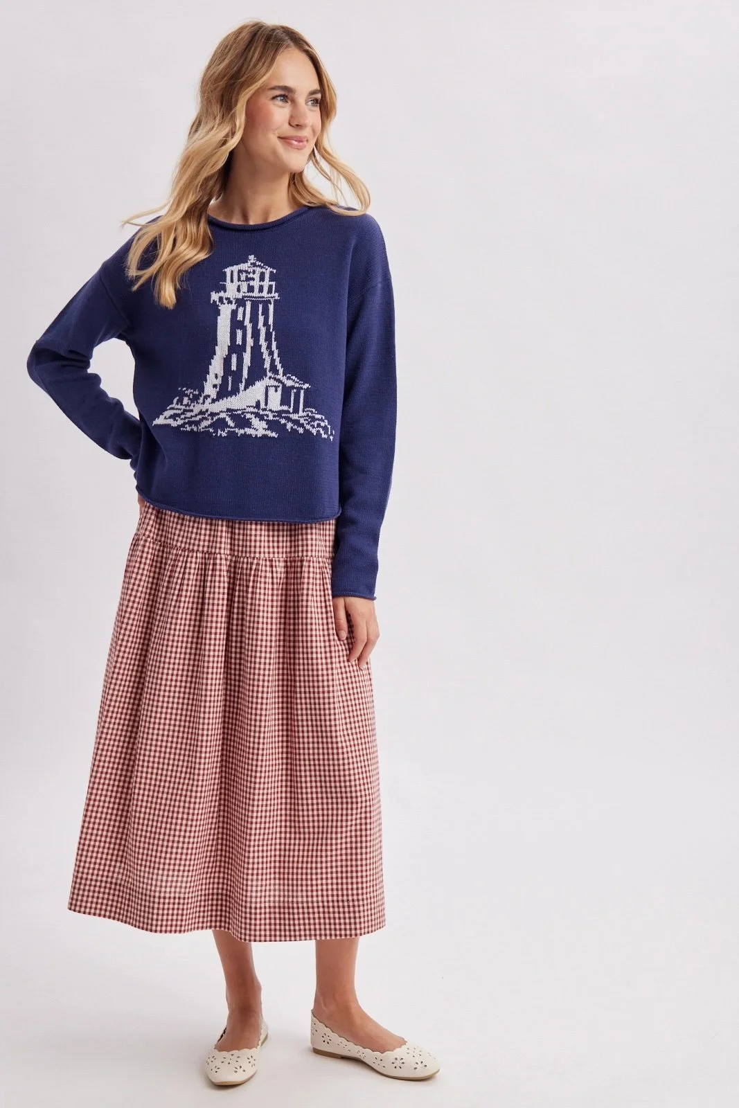Navy lighthouse sweater with white coastal lighthouse design, a nautical knit for fall.