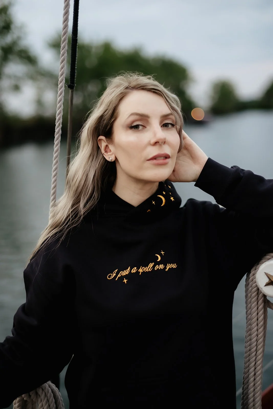Navy witchy graphic hoodie for fall and Halloween featuring a celestial wheel of fortune design with gold moon, stars, constellations and compass details.
