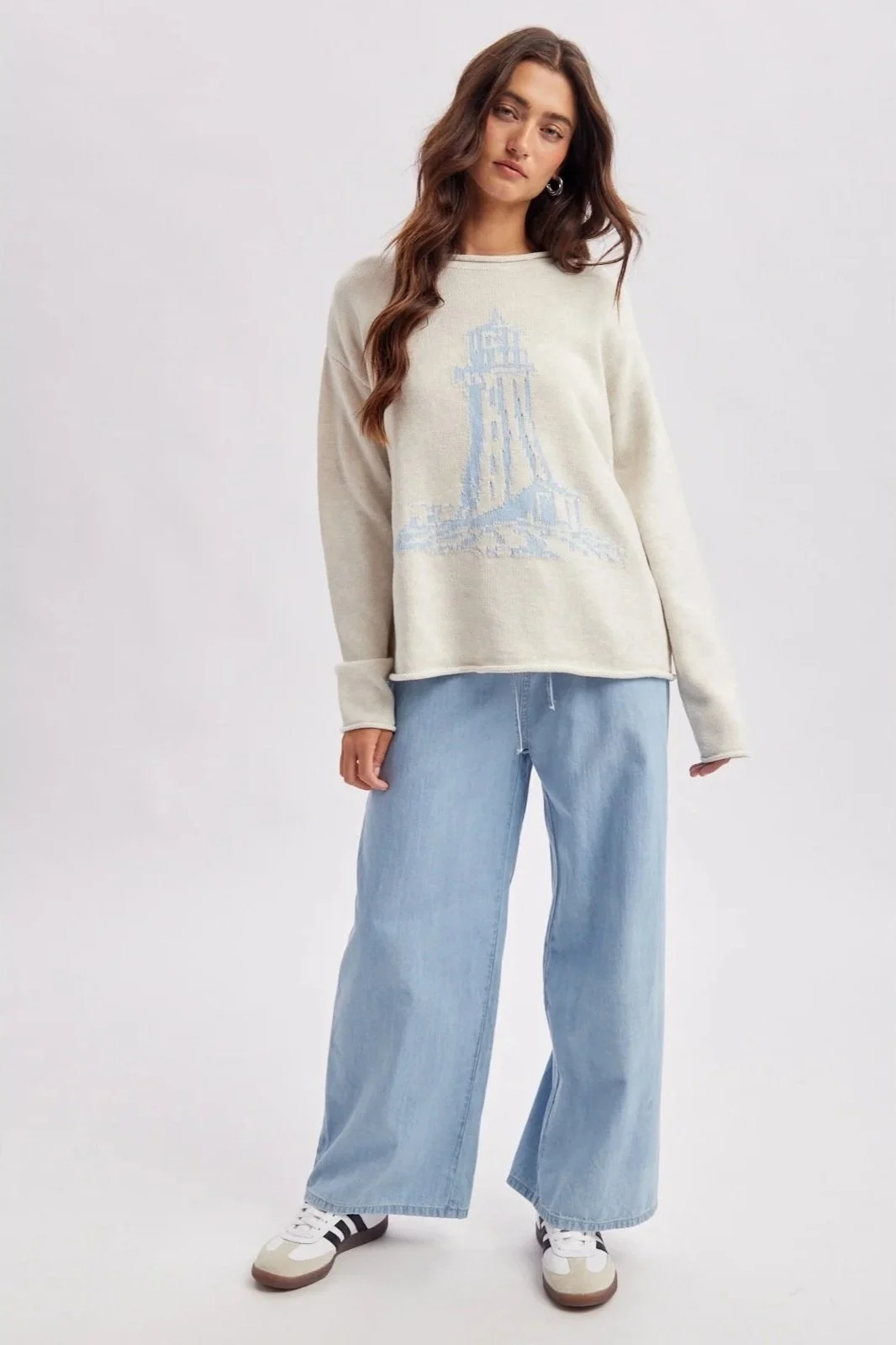 Ivory lighthouse sweater with light blue coastal lighthouse design, a nautical knit.