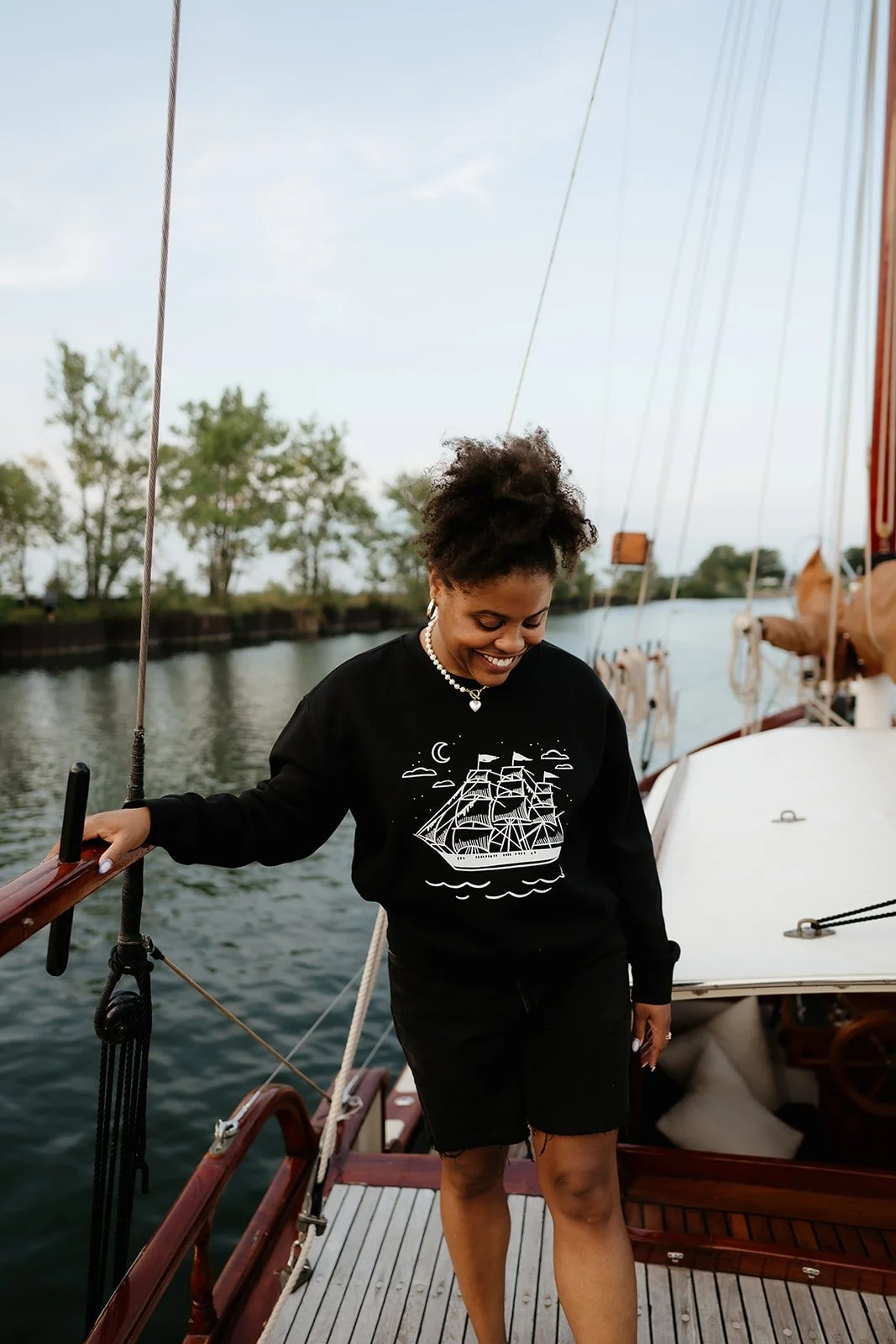 Ghost Ship crewneck sweatshirt in black with white vintage sailing ship, crescent moon, stars and subtle skull graphic.