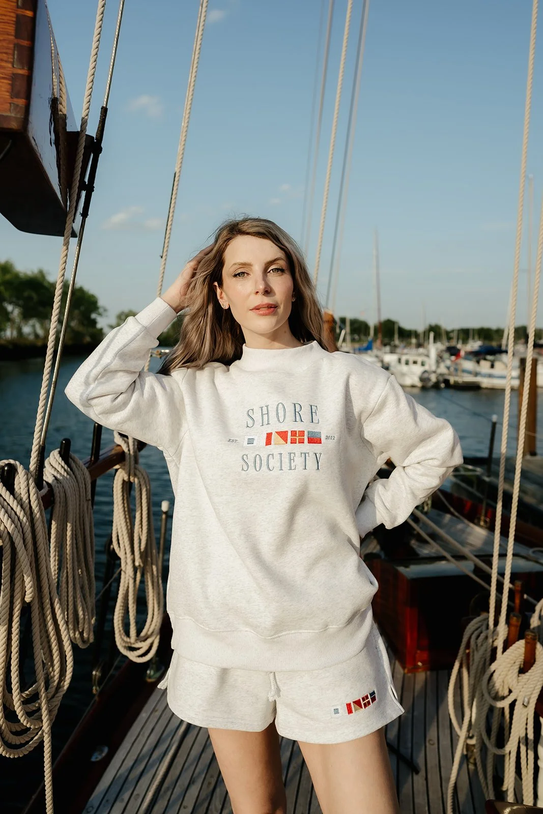 Heather gray lounge shorts with colorful nautical signal flag detail and drawstring waist, a preppy coastal matching set.