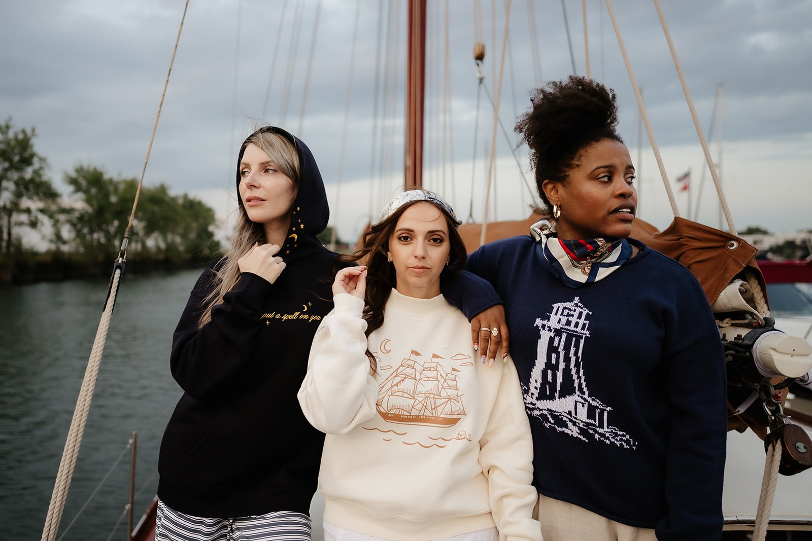 Ivory women’s Ghost Ship mockneck sweatshirt featuring a vintage sailing ship, crescent moon and skull graphic, a coastal Halloween sweatshirt for fall.