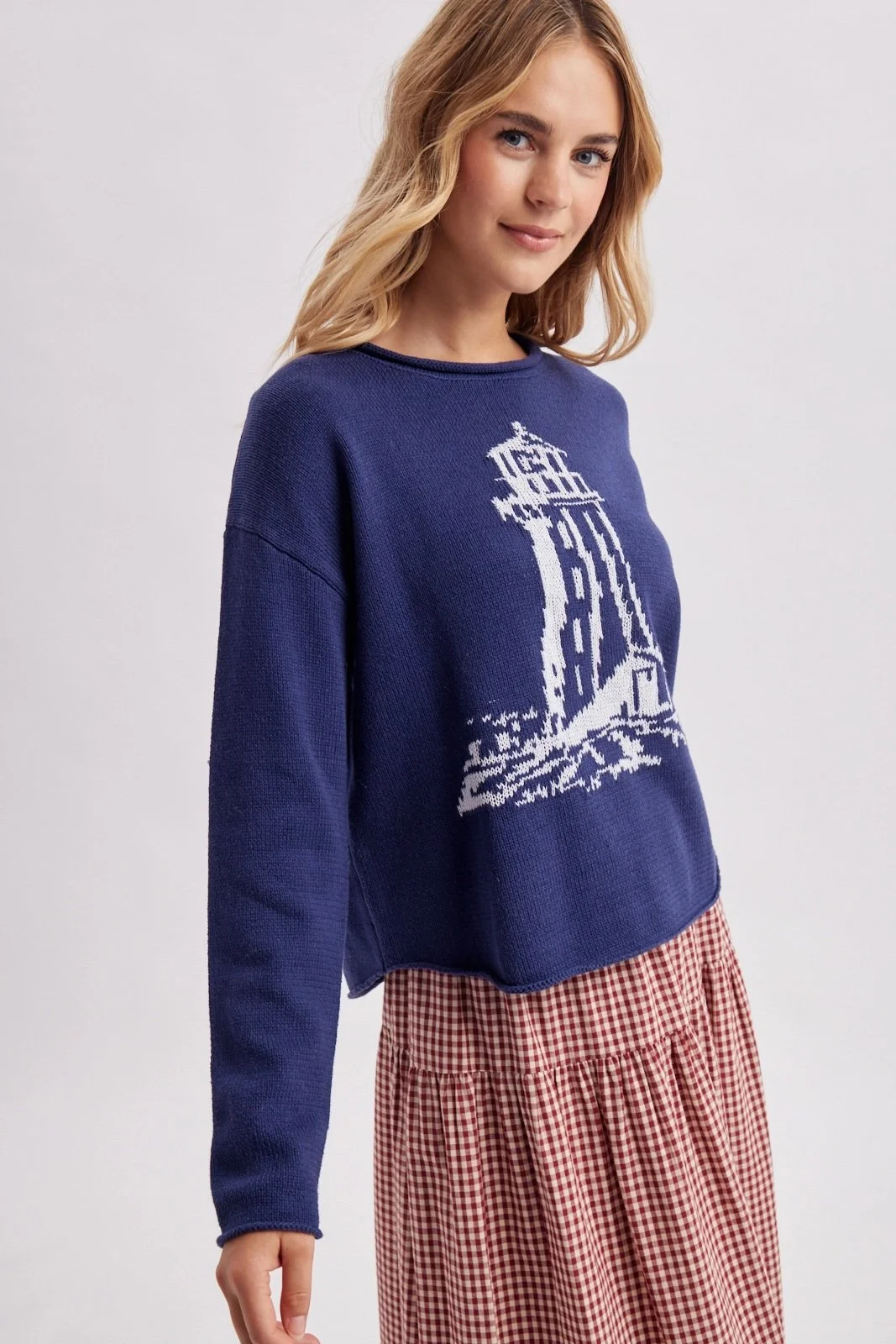 Navy lighthouse sweater with white coastal lighthouse design, a nautical knit for fall.
