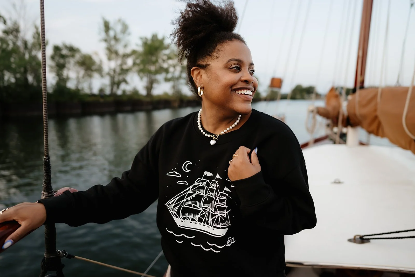 Ghost Ship crewneck sweatshirt in black with white vintage sailing ship, crescent moon, stars and subtle skull graphic.