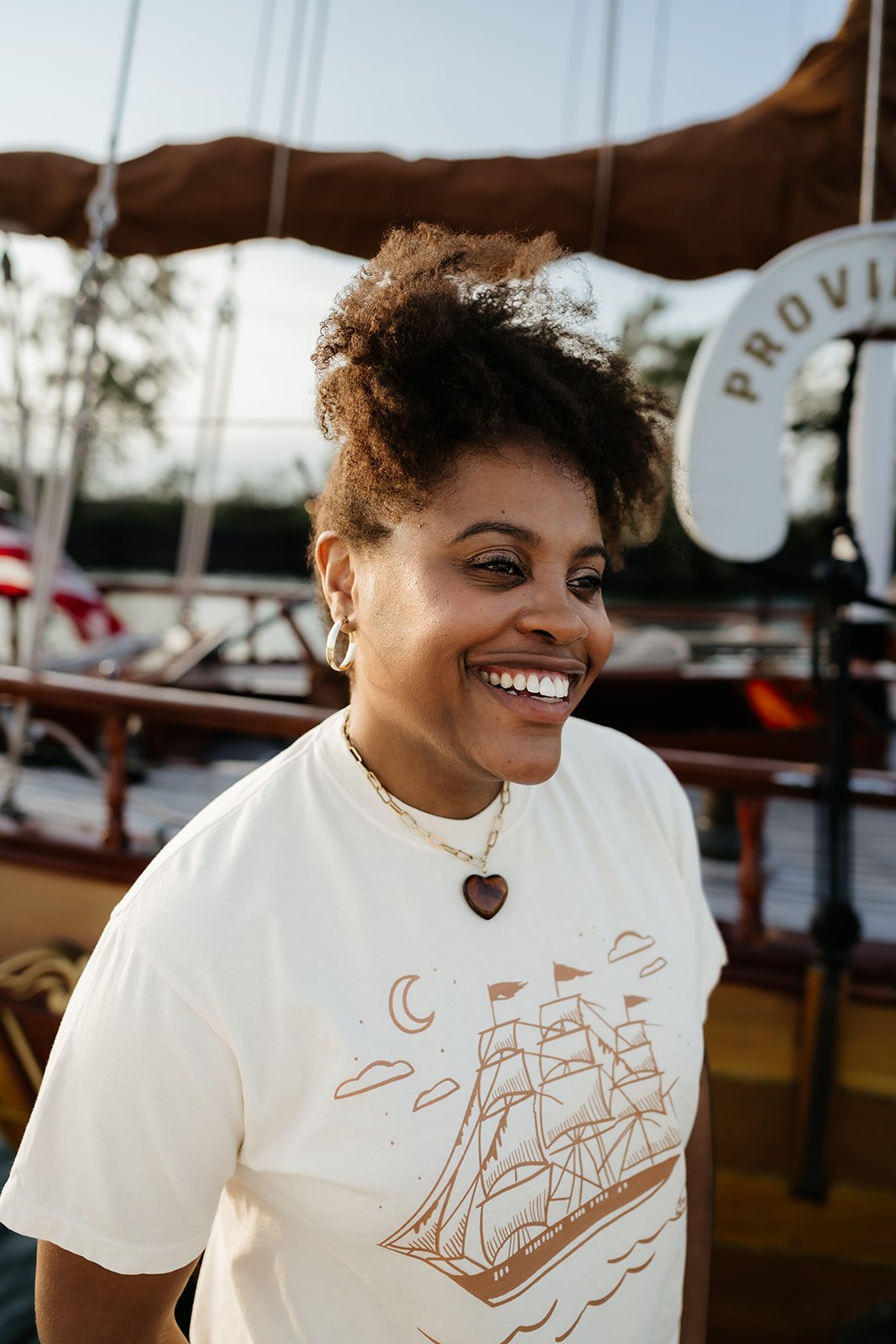 Ivory Ghost Ship graphic tee with vintage sailing ship, crescent moon and skull design, a coastal Halloween t-shirt
