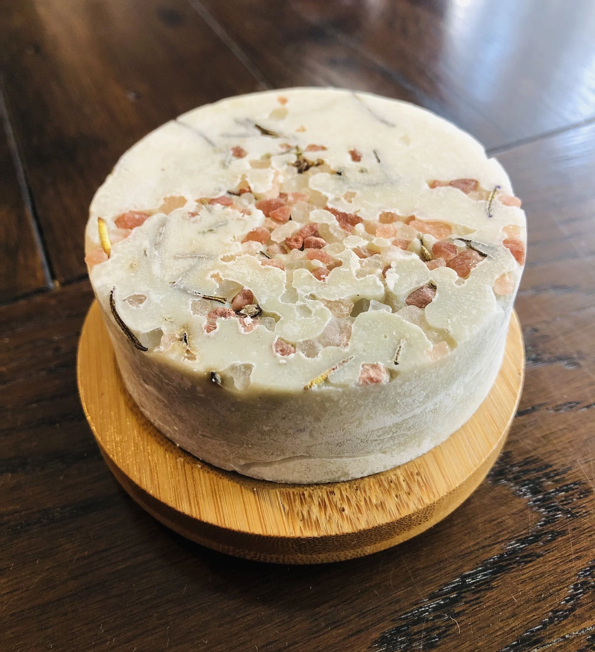 Wooden round bamboo soap dish with a wild māra salt soap