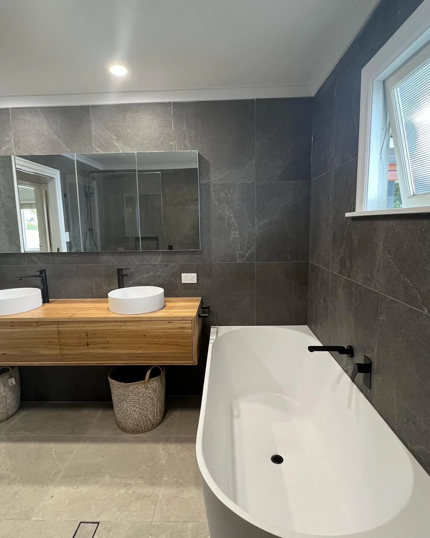 Large bathroom renovated in Brisbane with double vanity and corner bath tub
