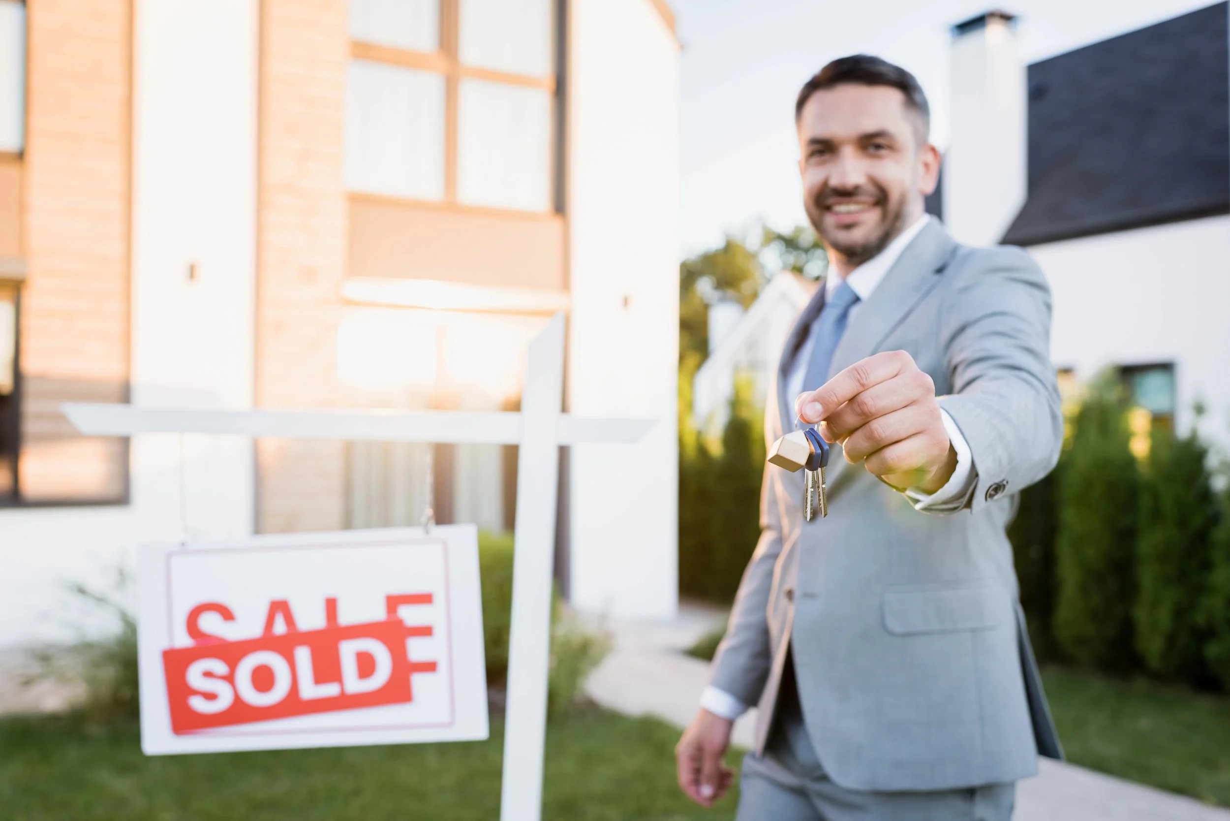 Real estate agent offering keys to new property owners