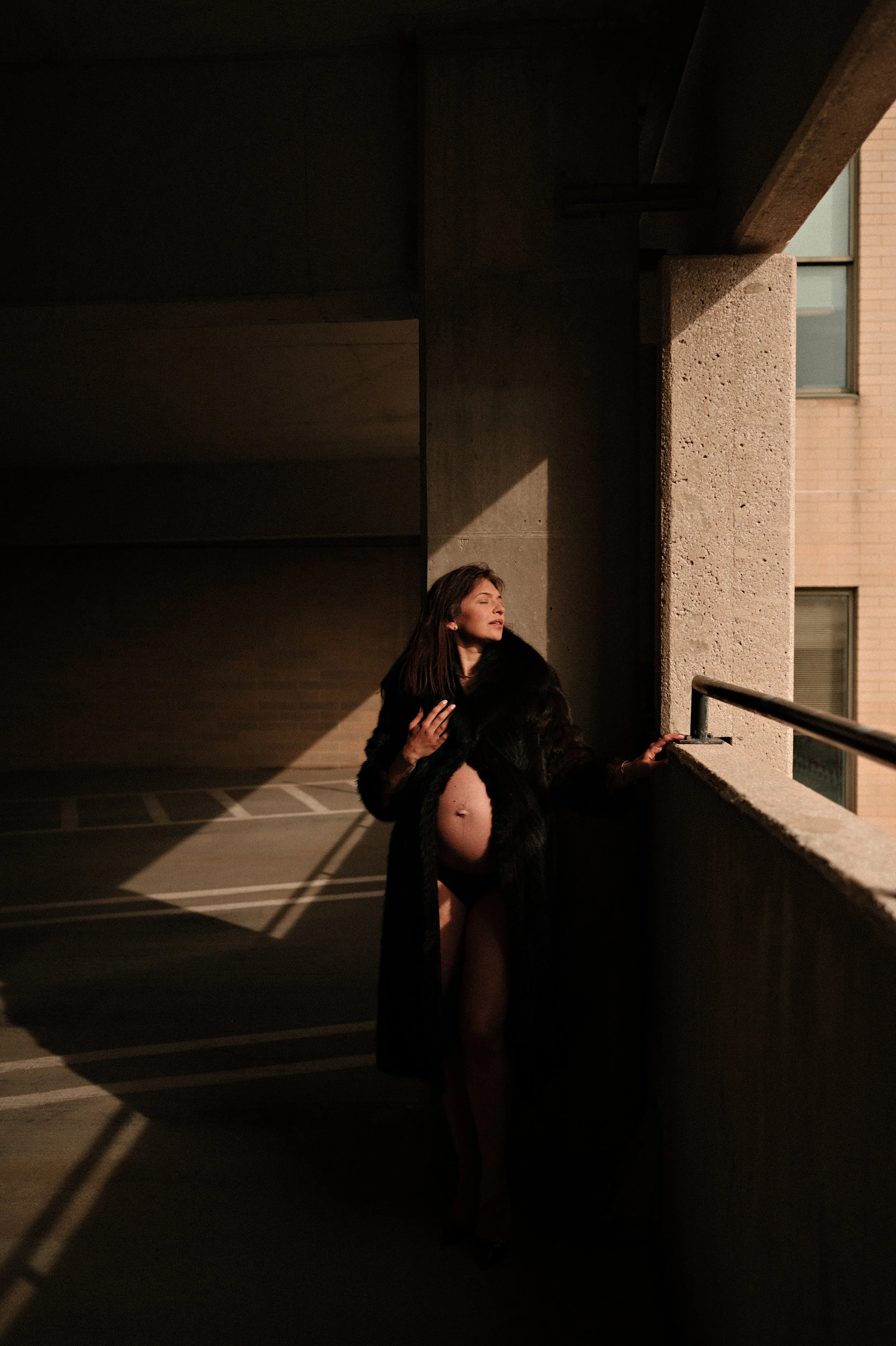 maternity photos in akron ohio parking deck fur coat and bare belly