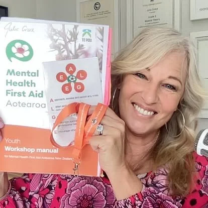 Julia Grace holding Be Kind to Your Mind book