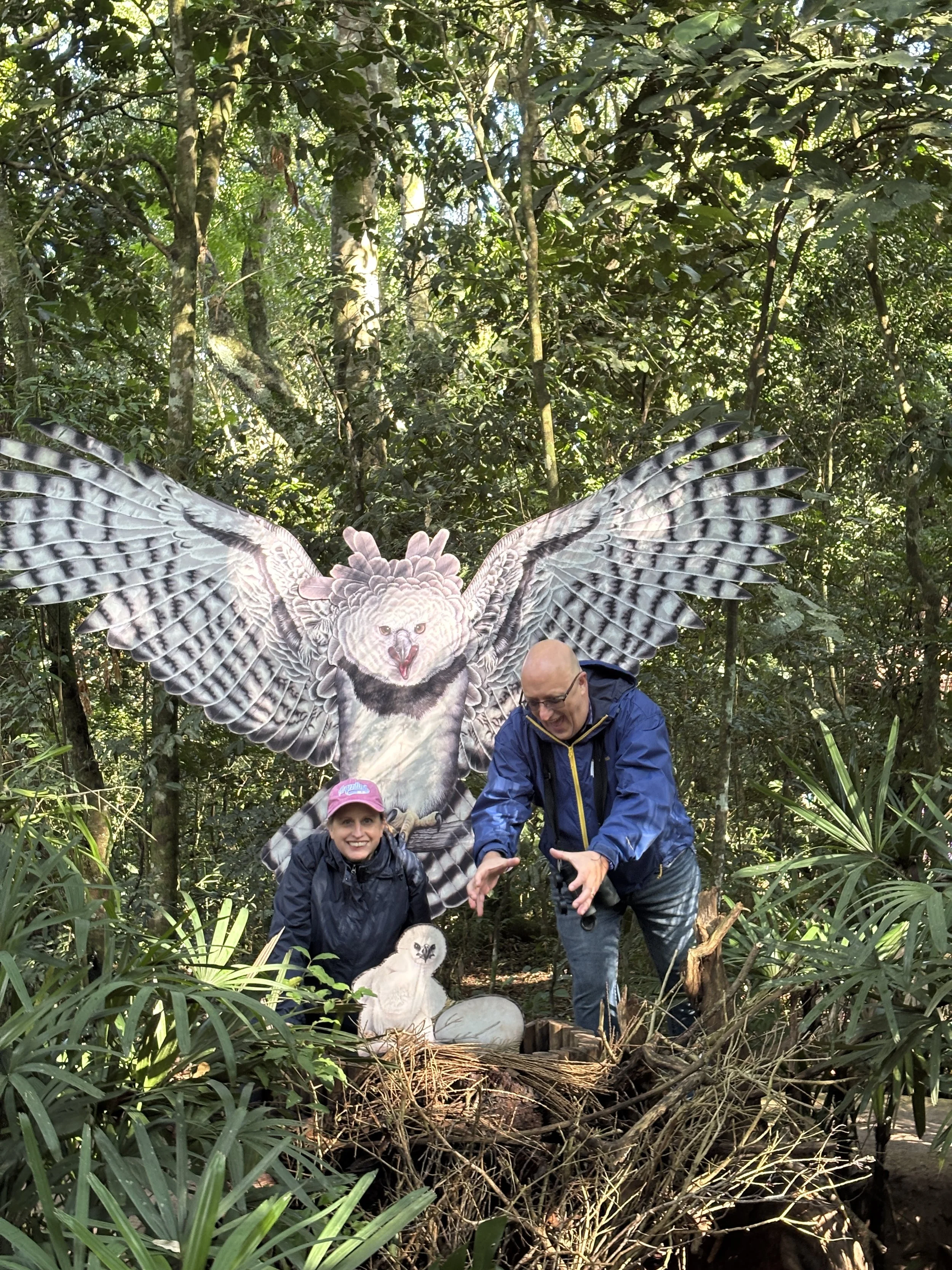 Man and woman in front of a Harpy Eagle figure.