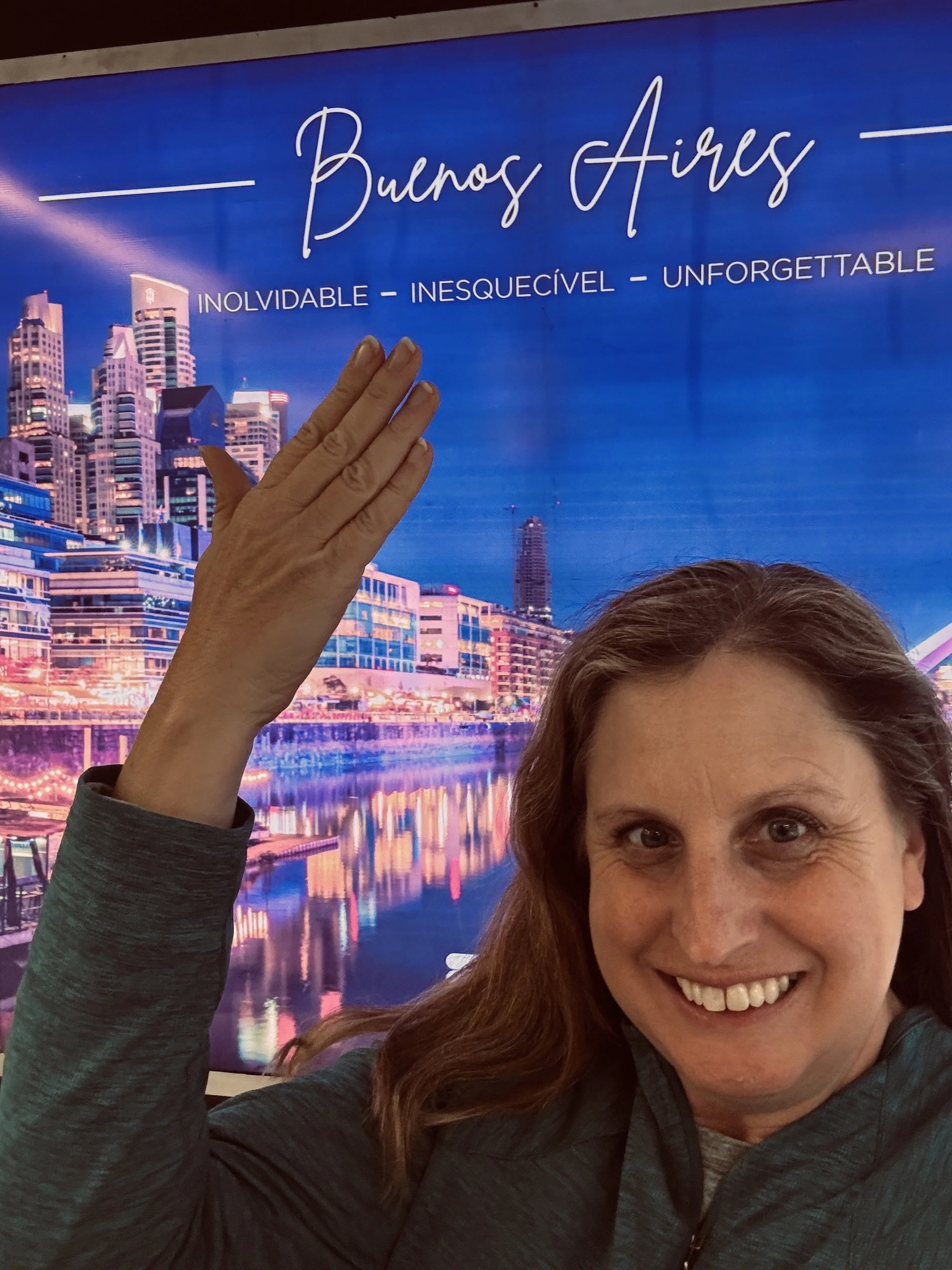 Woman pointing to the sign, "Buenos Aires"