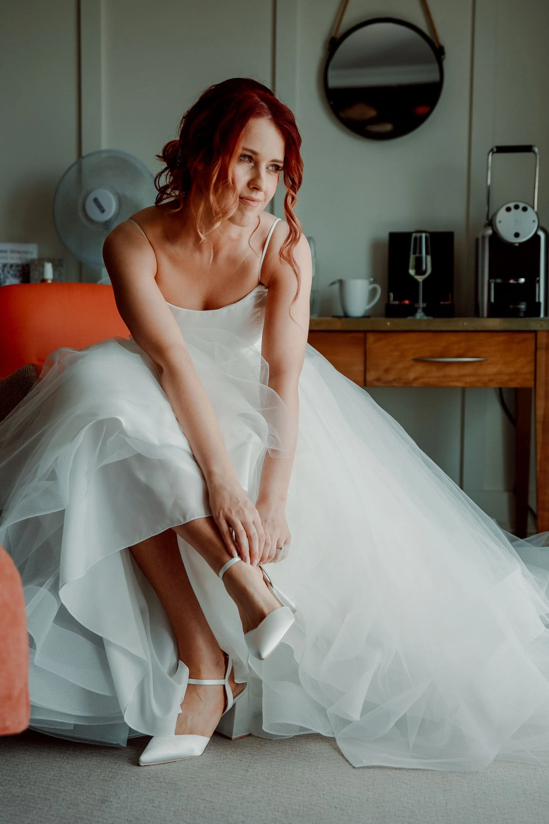 Garryvoe summer wedding in cork, bride tying her shoes