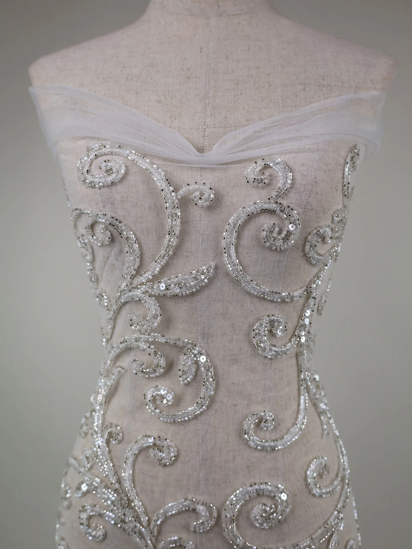 NEW ARRIVAL
F7073 Scrolls &middot; Beaded Tulle &middot; Ivory/Silver &middot; 132cm wide

A dramatic scrollwork tulle with couture-level sparkle and beautiful movement. The design is built from luminous silver beading and sequins, laid in sweeping, 