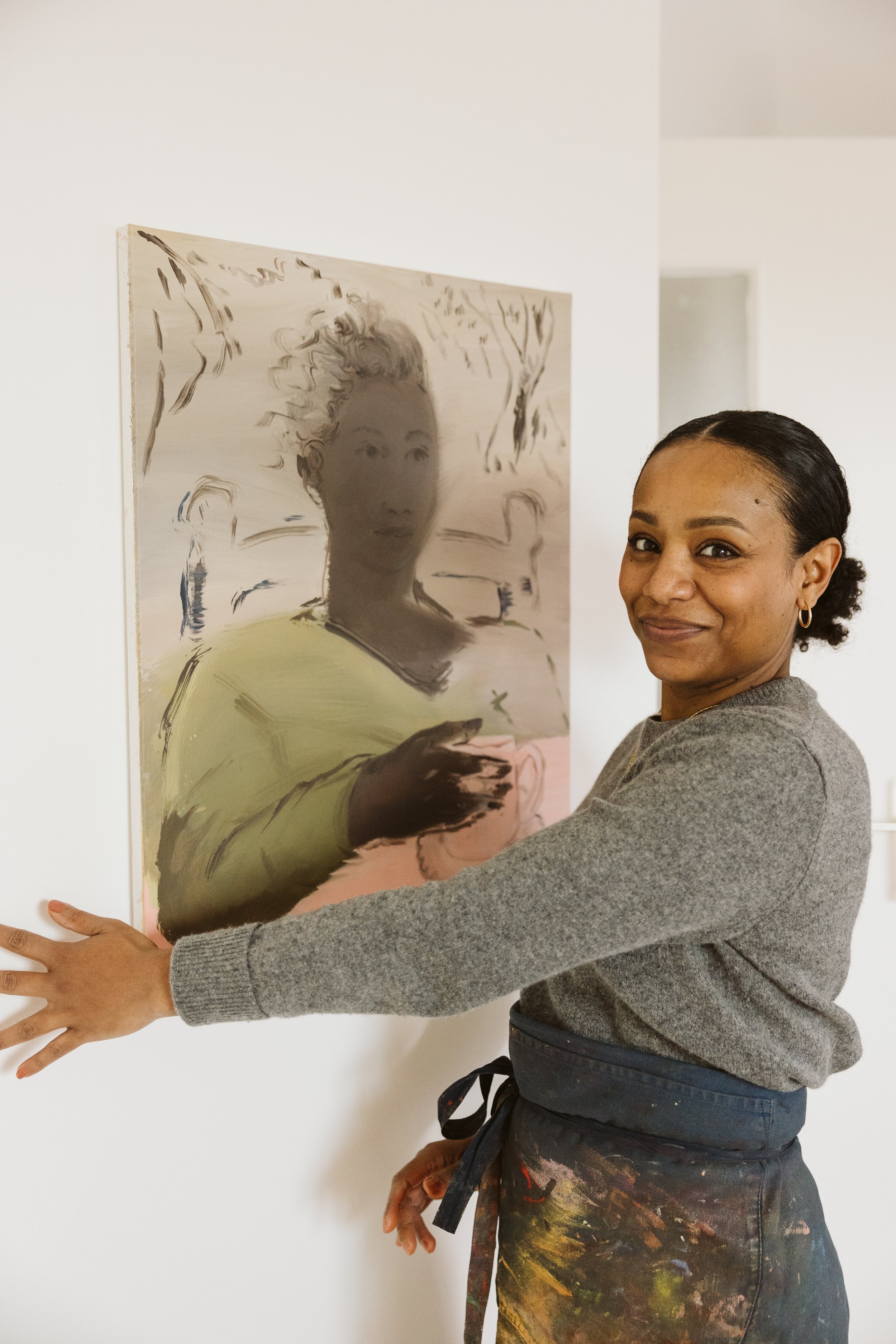 Portrait de l'artiste peintre Marie Michelle Le Millier dans son atelier en Bretagne avec une de ses peintures à l'huile.