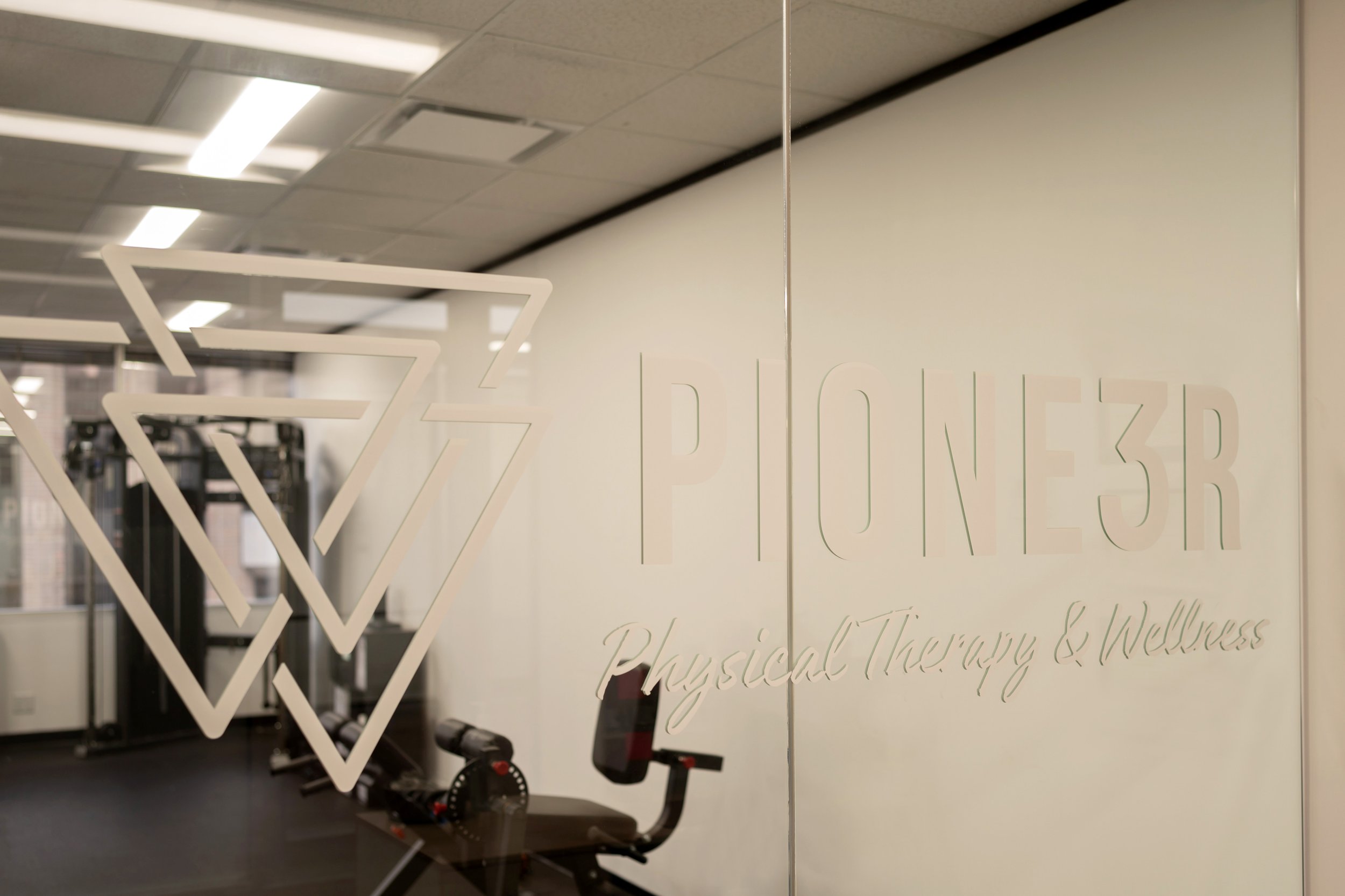 PIONE3R Physical Therapy clinic interior in Houston TX showing fully equipped gym space for postpartum rehabilitation and strength training